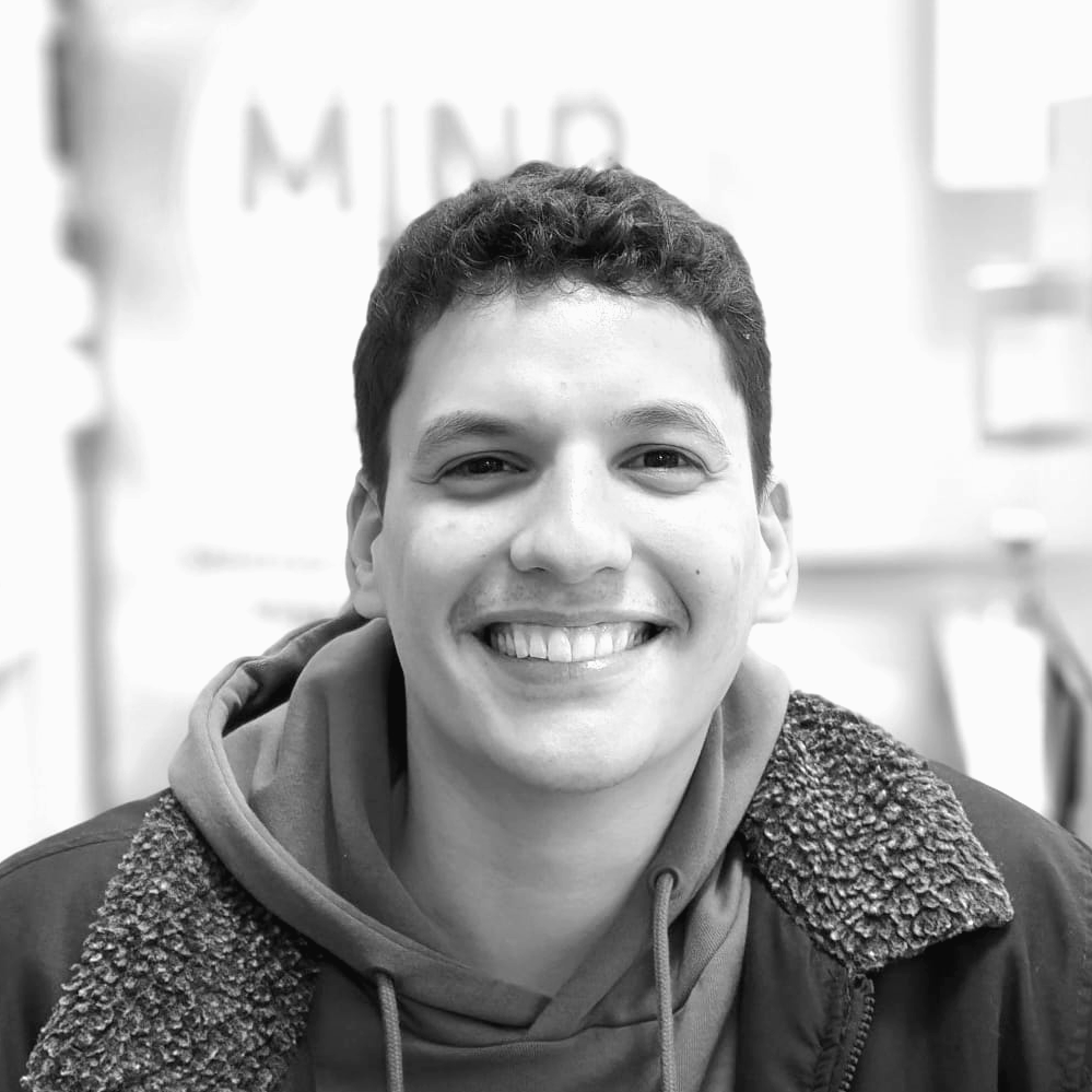 Icon of a person with goggles smelling a test tube with bubbles, symbolizing safety and chemistry or science.