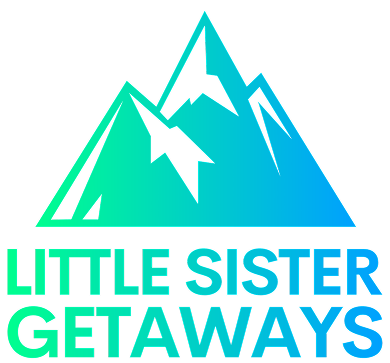 A logo with stylized mountain peaks in shades of blue and green, featuring the text 'LITTLE SISTER GETAWAYS' in bold green and blue letters.
