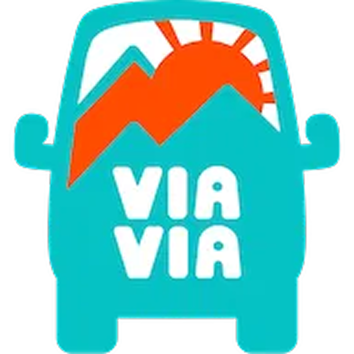 Cartoon character resembling a cactus with a mountain and sun on its head, and the text 'VIA VIA' on its body.