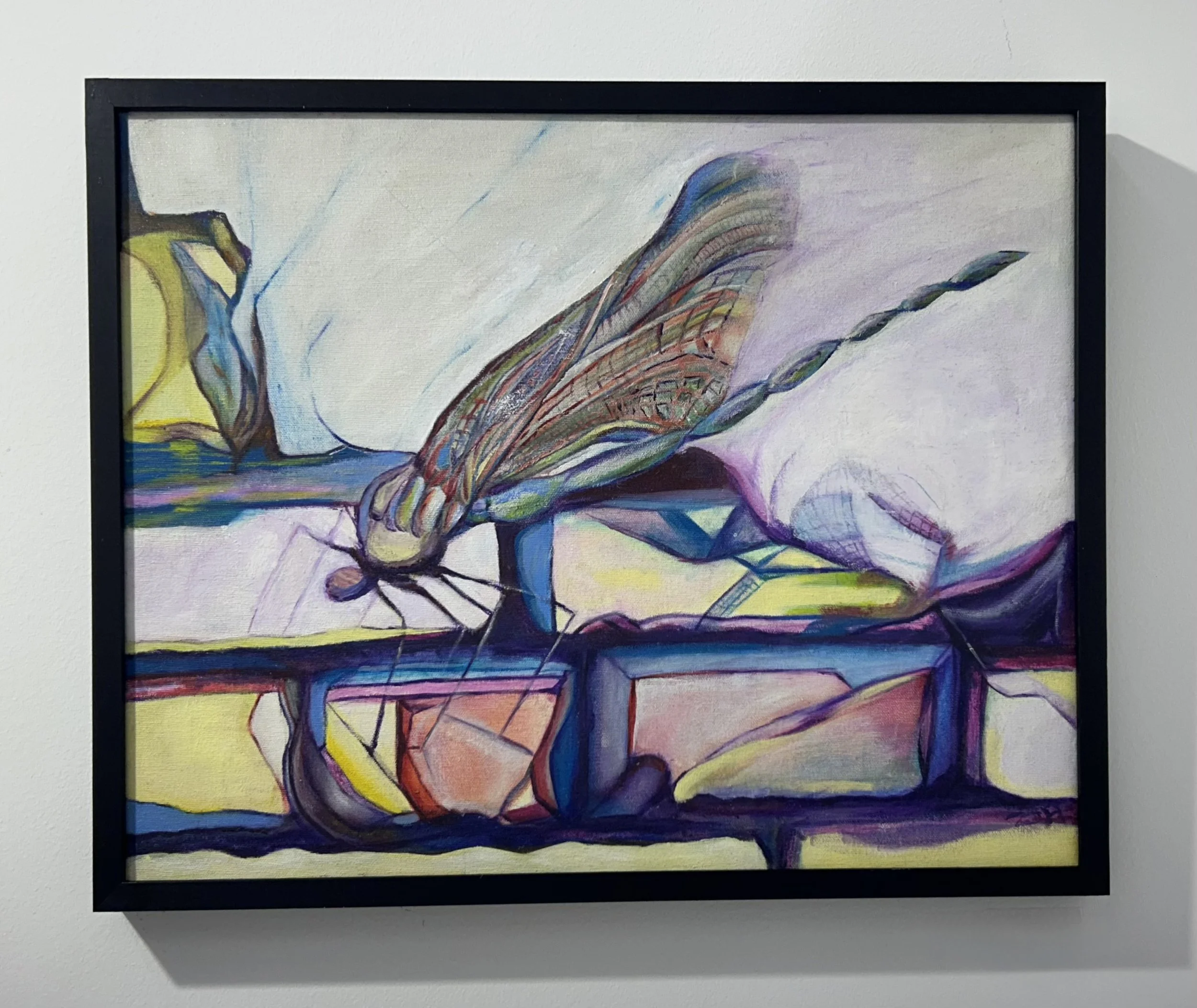 Abstract painting with vibrant colors and swirling patterns framed on a white wall.
