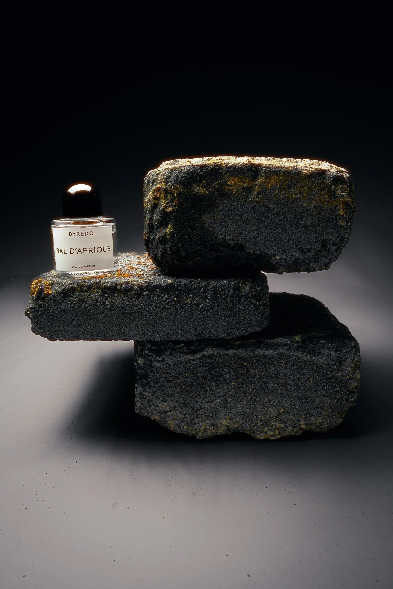 Byredo perfume photographed on rocks – surreal editorial magazine product photography