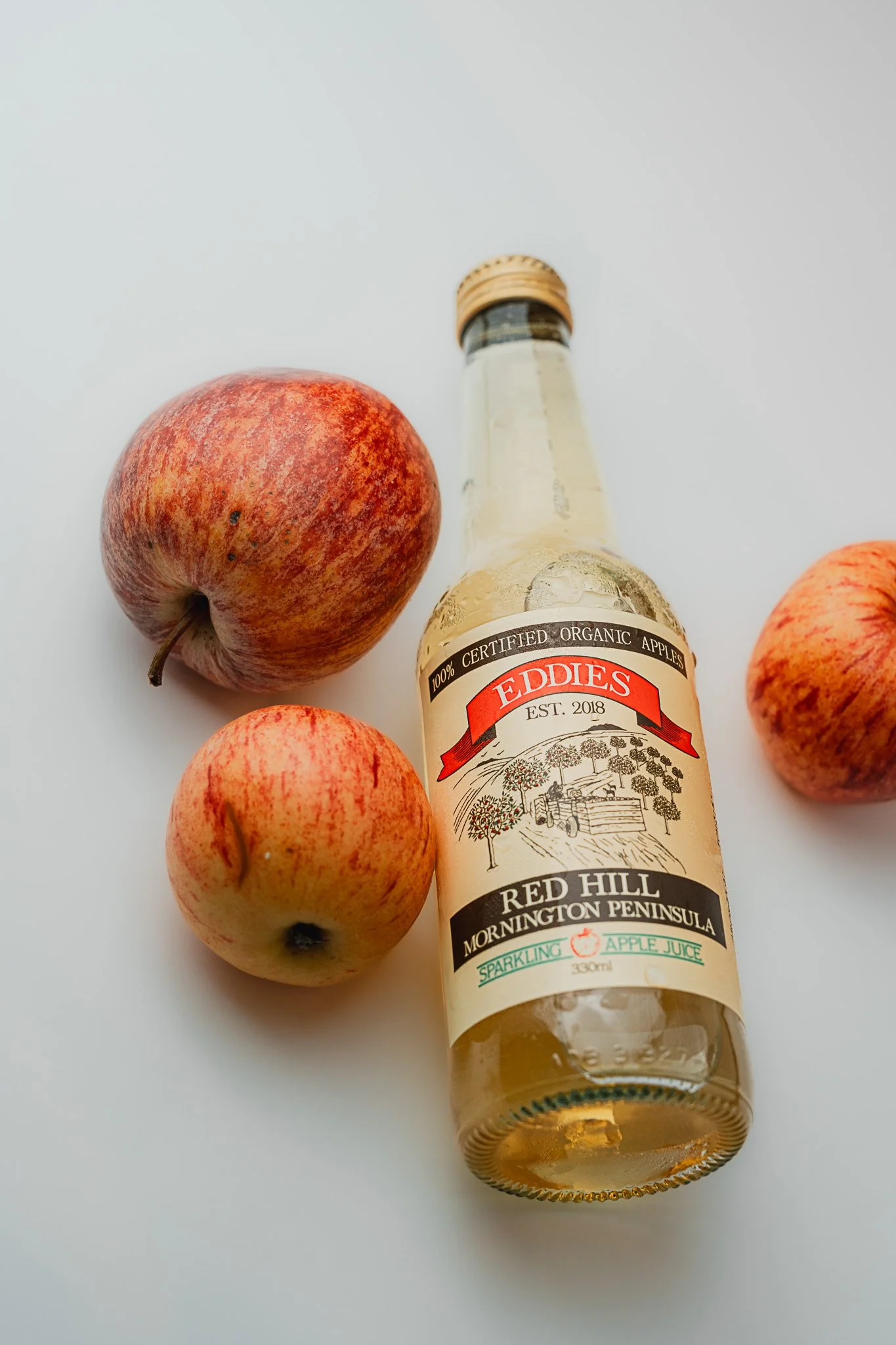 Minimalist Eddies Sparkling Apple Juice from Red Hill in Mornington Peninsula styled in natural daylight – product photography for makers