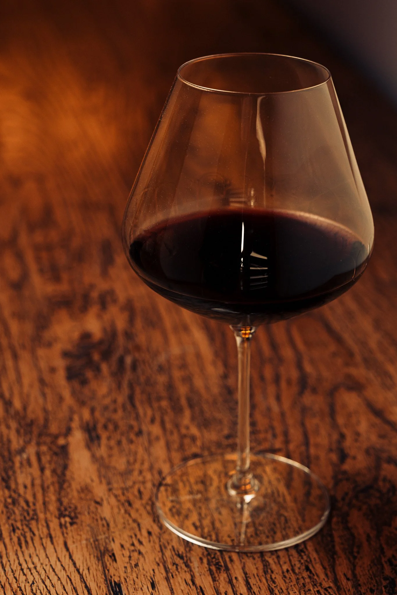 Plumm wine glass product photography – styled in lifestyle settings with timber