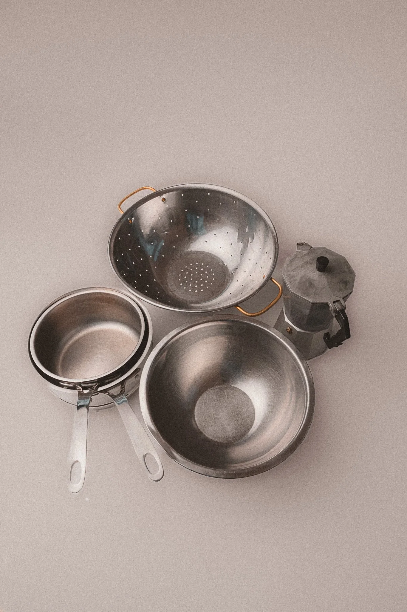 Editorial kitchenware pots in studio with white backdrop