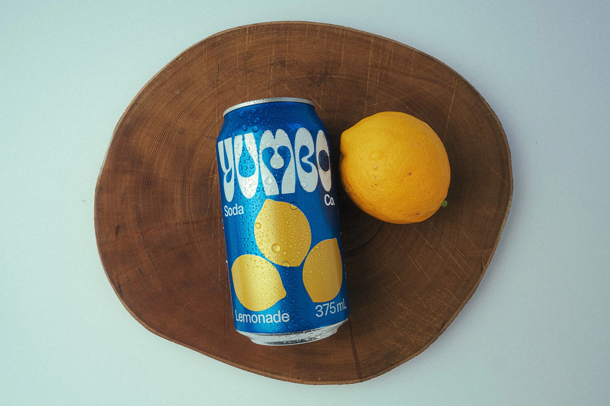 Yumbo soda can product photography - Lemonade and wooden stump