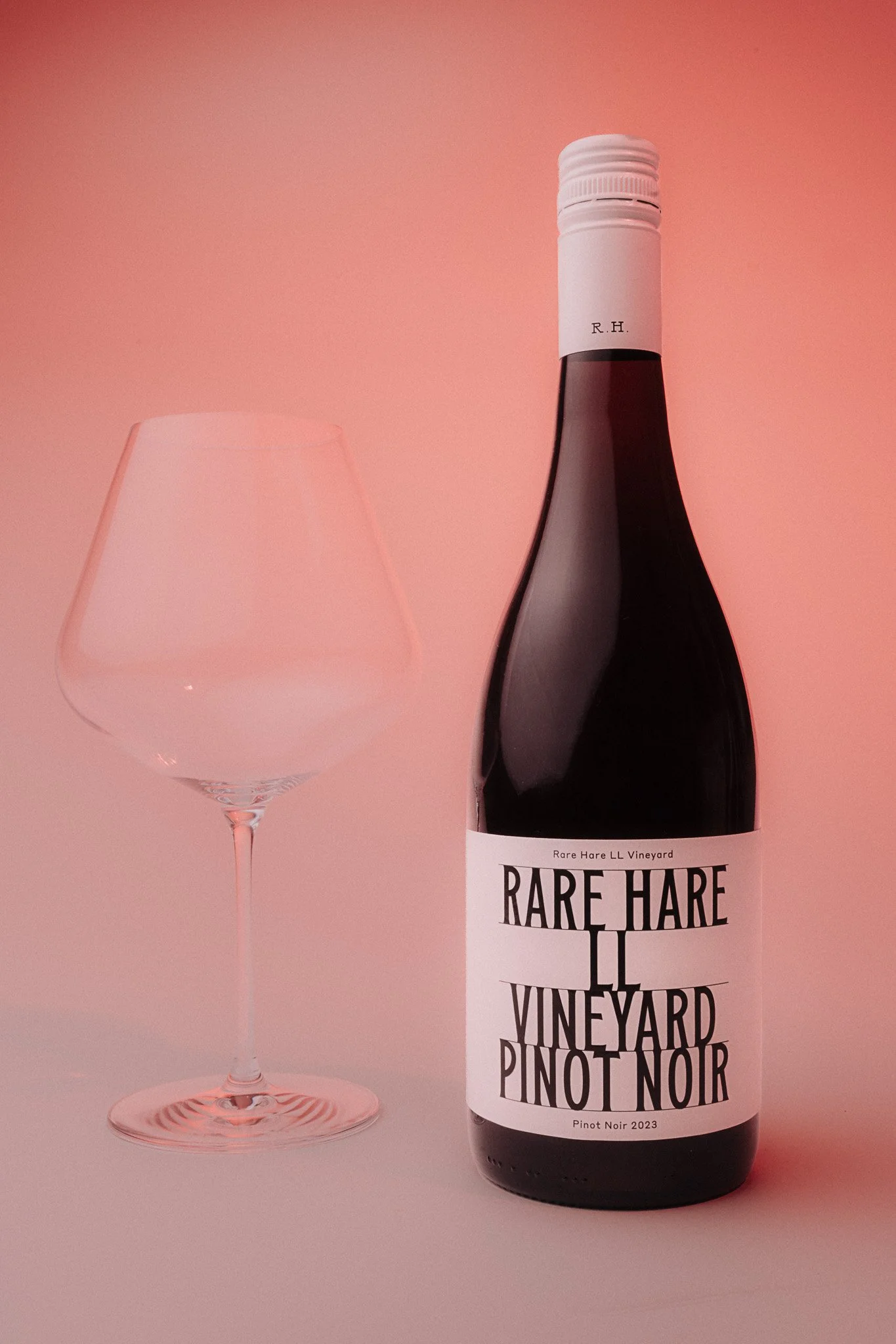 Rare Hare Pinot Noir bottle – surreal studio product photography with red lighting