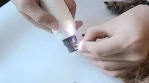 Using a nail grinder to trim a dog's nails