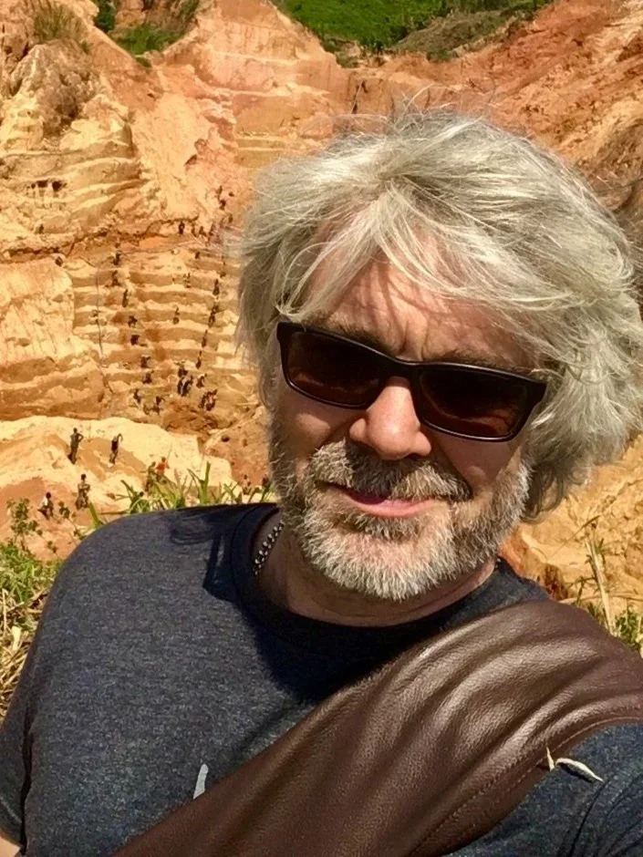 Greg Valerio MBE standing in front of a massive artisanal gold mine in Democratic Republic of Congo