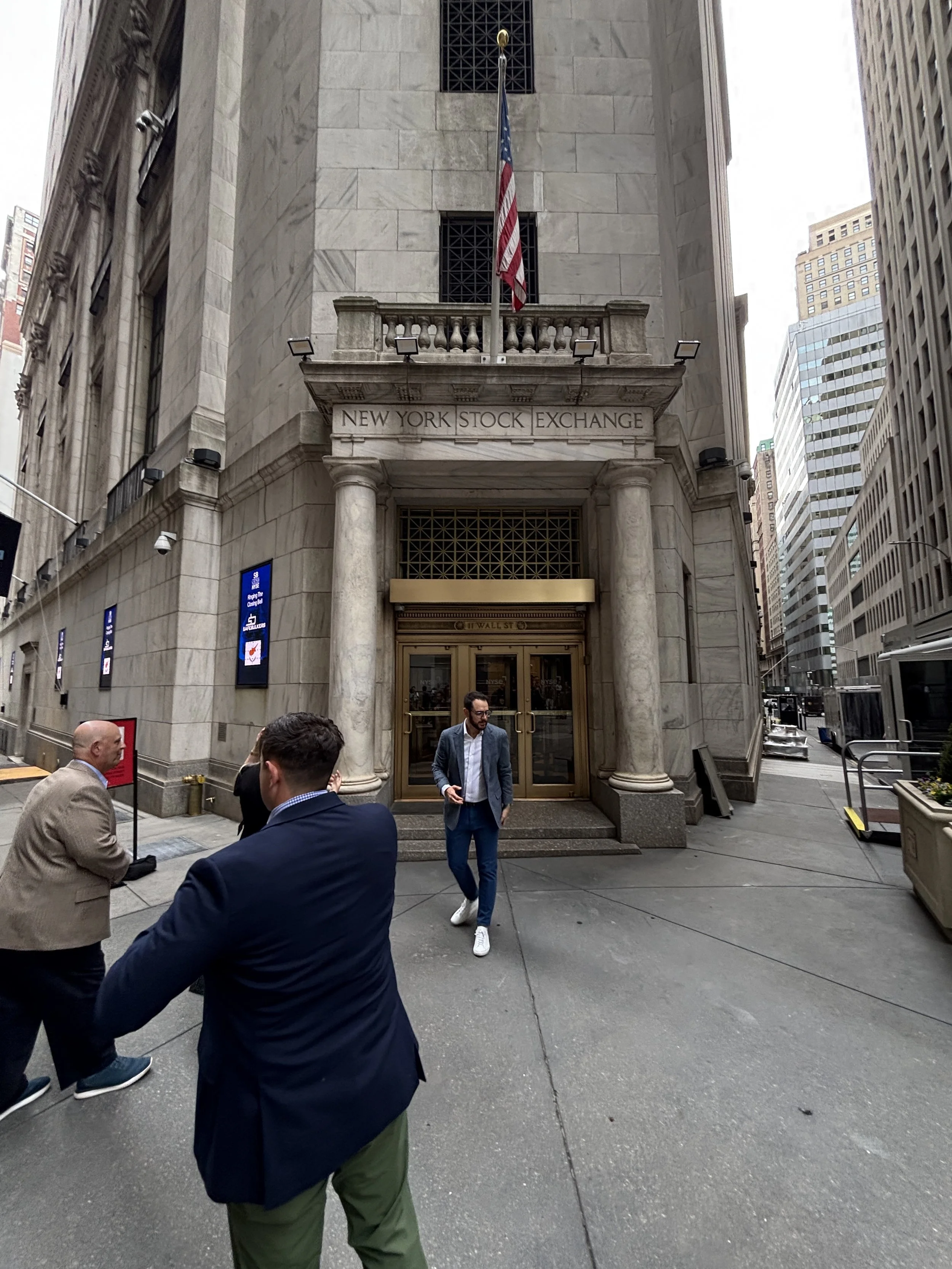 People walking past the entrance of the New York Stock Exchange building in Manhattan.