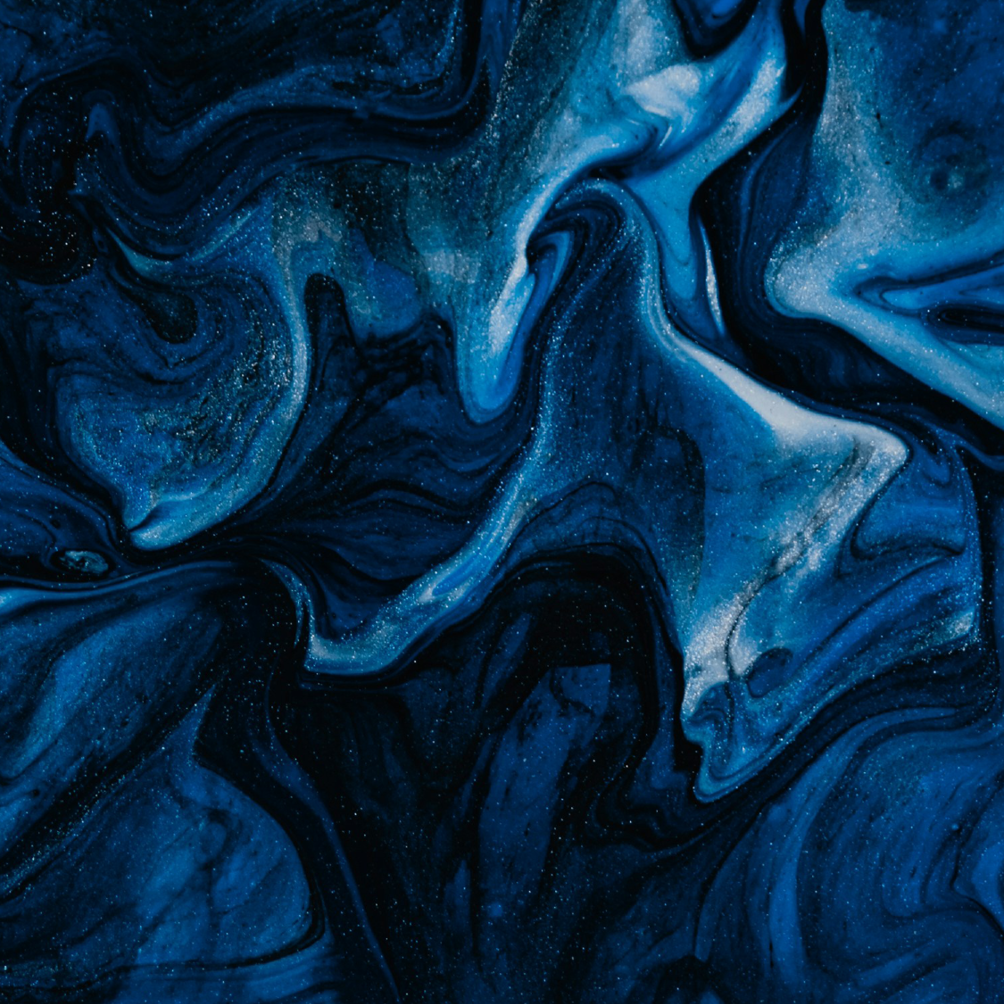 Abstract blue and black marbled pattern with hints of white and specks of glitter.