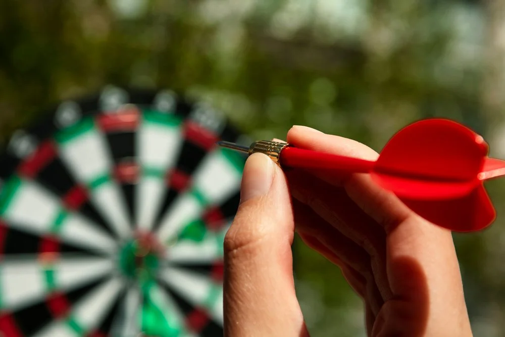 hand-throwing-dart-arrow-board-wo.jpg