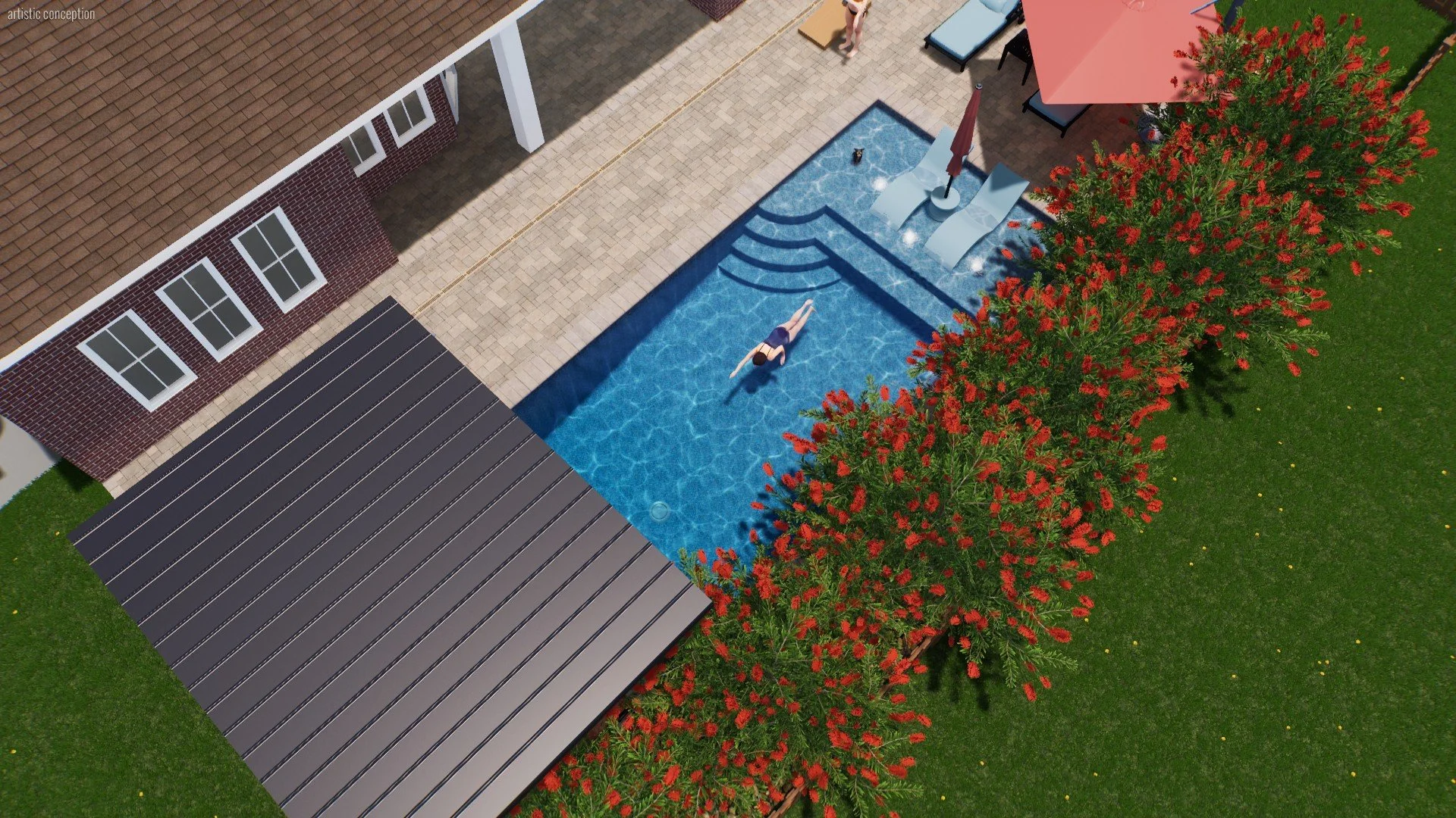 A backyard with a swimming pool, a person floating on a pool float, a patio with a lounge chair and table with an umbrella, a covered deck area, a brick house with snow on the roof, and red flowering bushes along the grass.