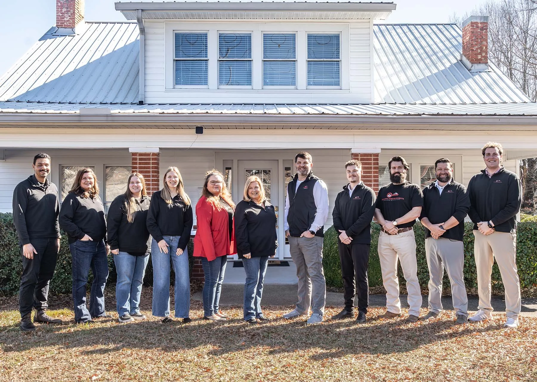 The Selling North Georgia Realty team standing shoulder to shoulder for a team photo outside of the Selling North Georgia Realty office