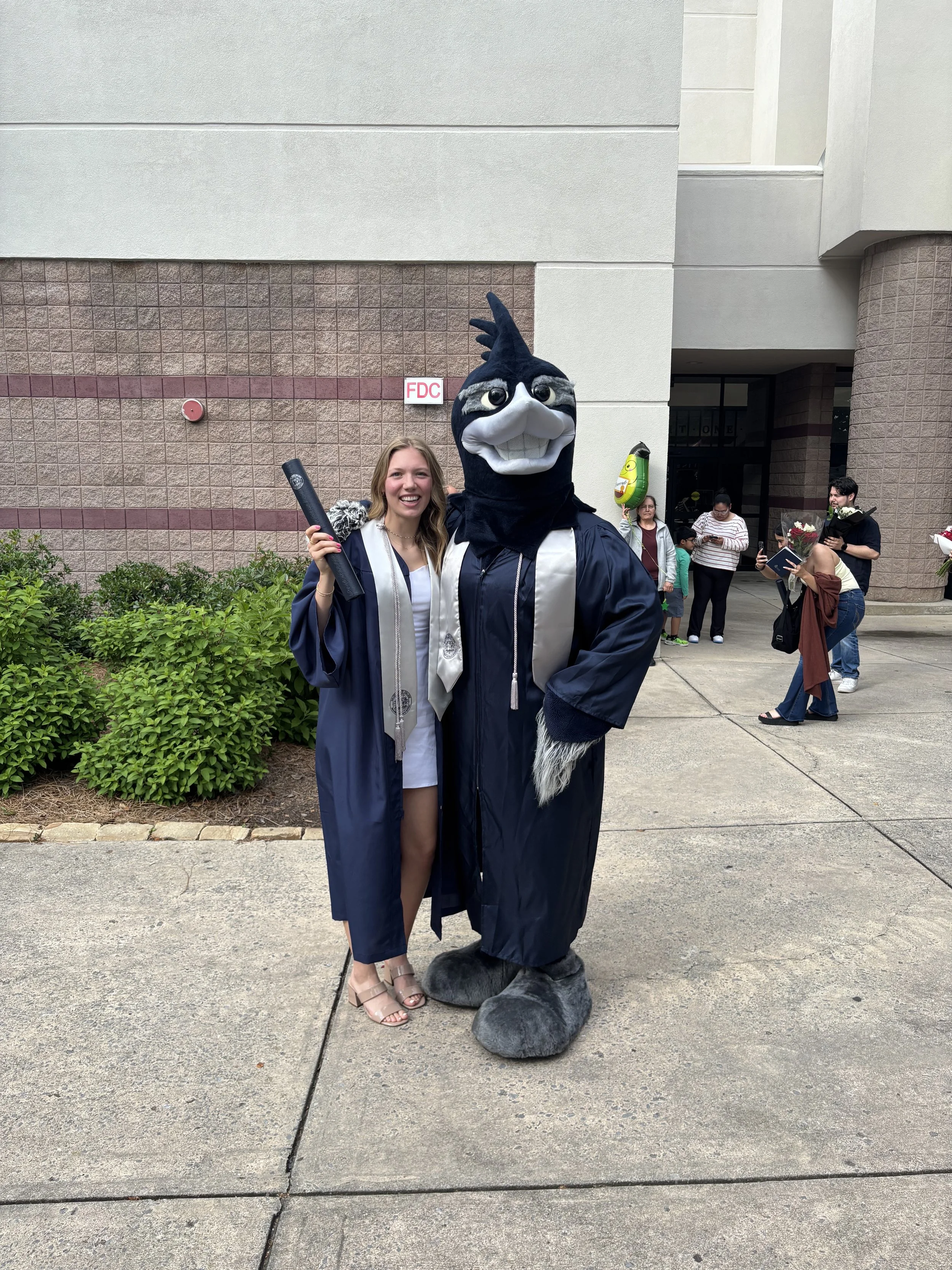 Tatum posing with a mascot