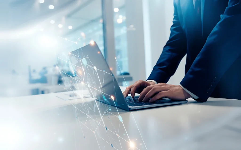 Two professionals in suits working on a laptop in a modern office with a digital network overlay.