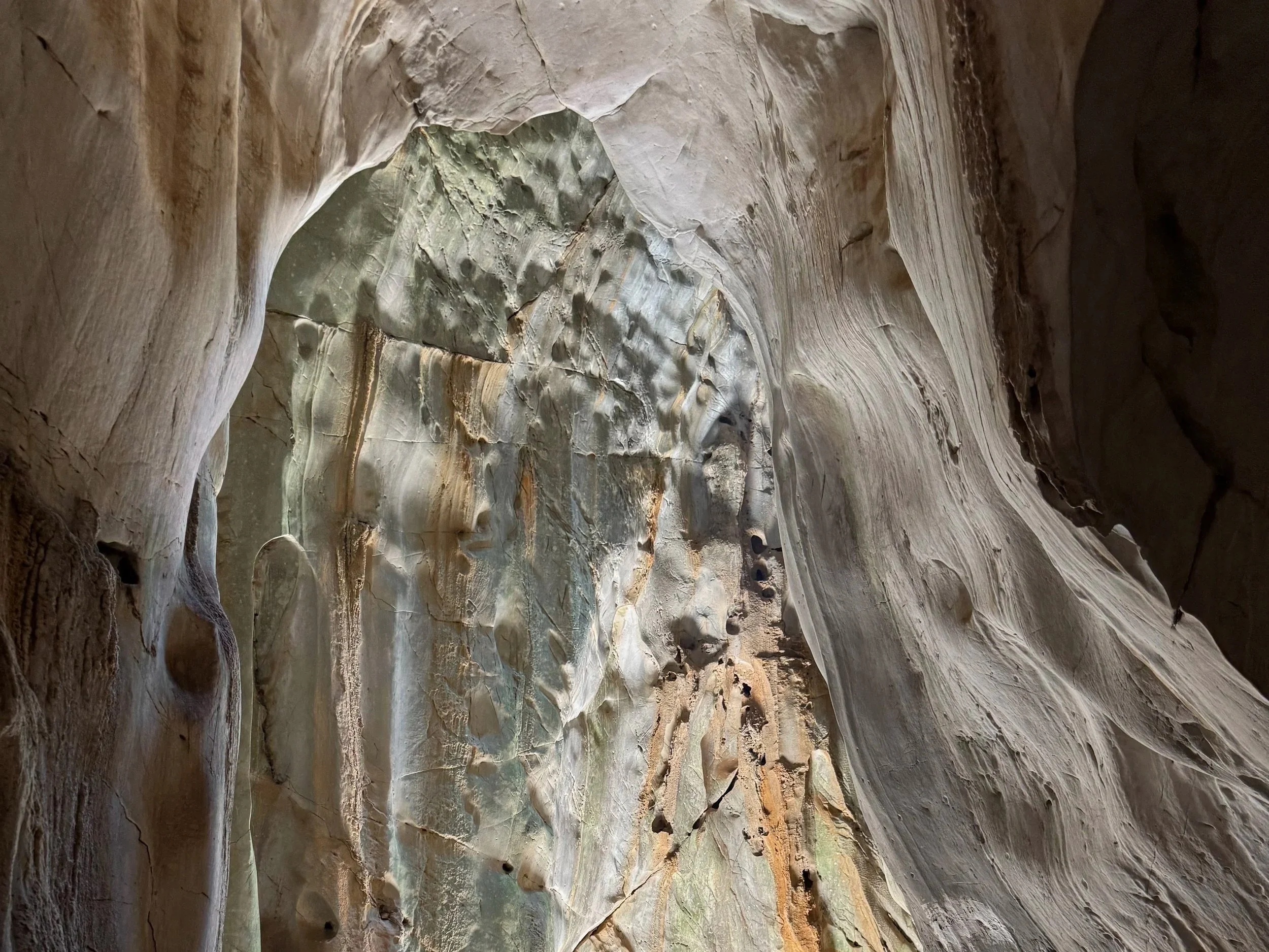 A carved face in a sandstone canyon wall.