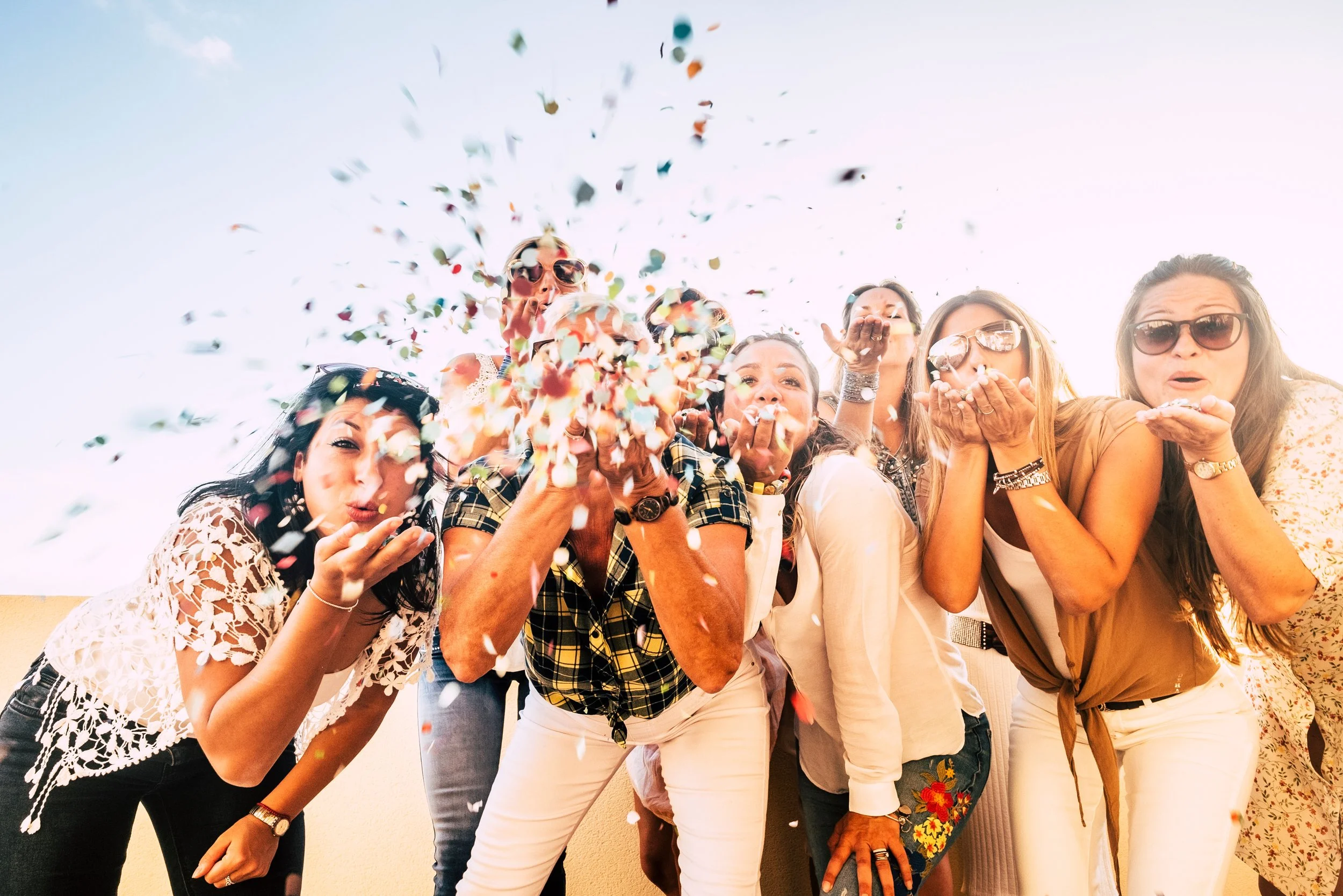 Group of women celebrating with confetti.