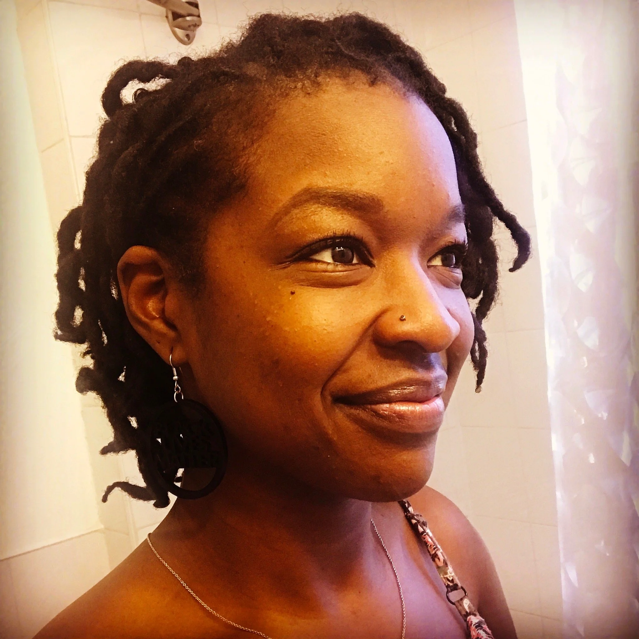  Rachel Cato smiles while glowing in a soft, yellow light. 