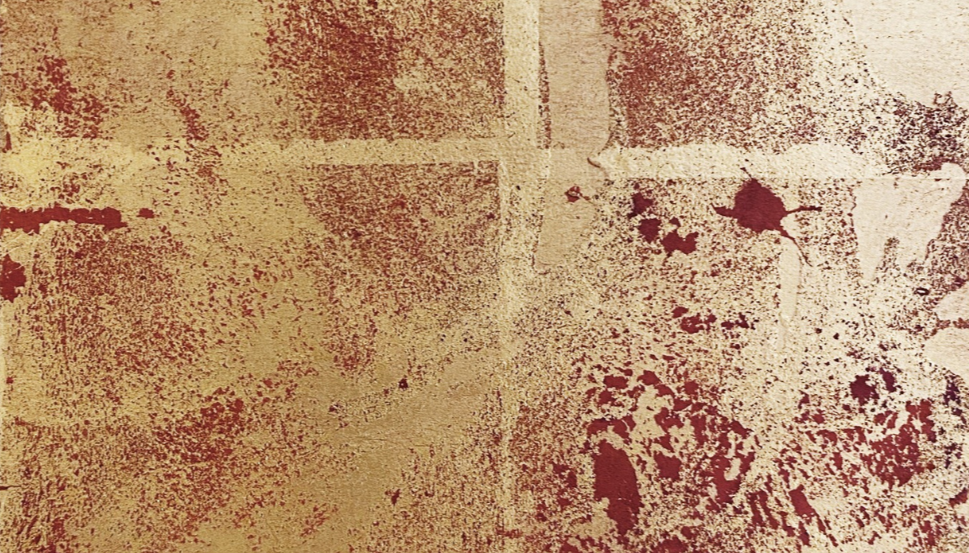 Close-up of a textured, stained wall with a mix of beige and reddish-brown colors.