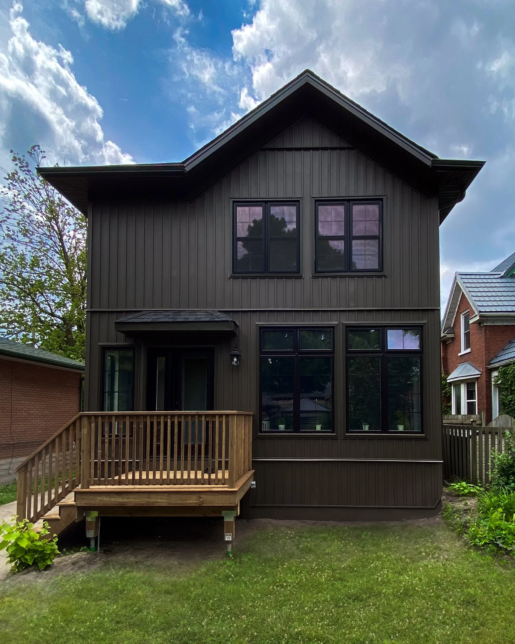 Two Storey Home Addition Featuring Vinyl Siding, Custom Windows and Rear Deck.