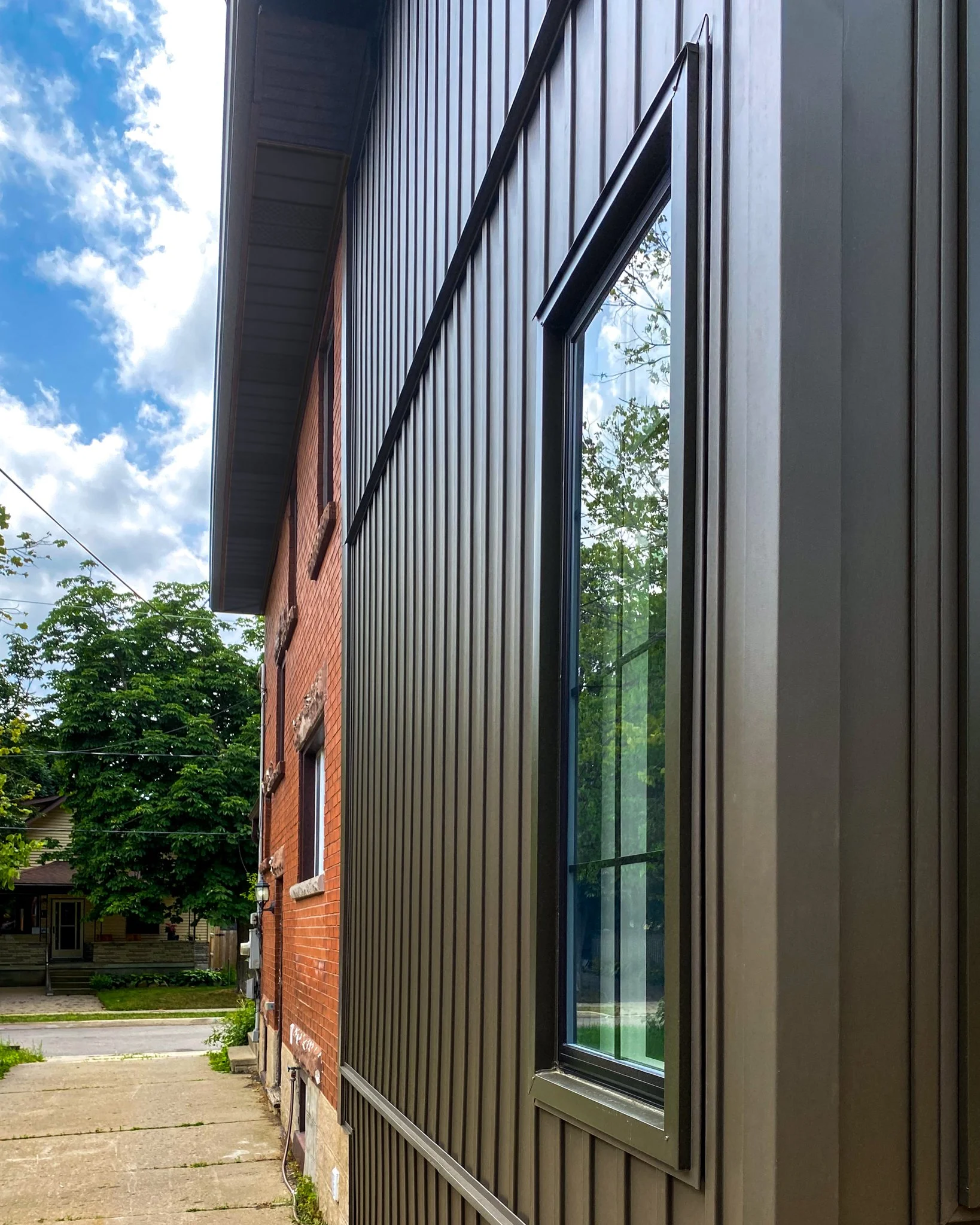 Two Storey Home Addition Featuring Vinyl Siding and Custom Windows.
