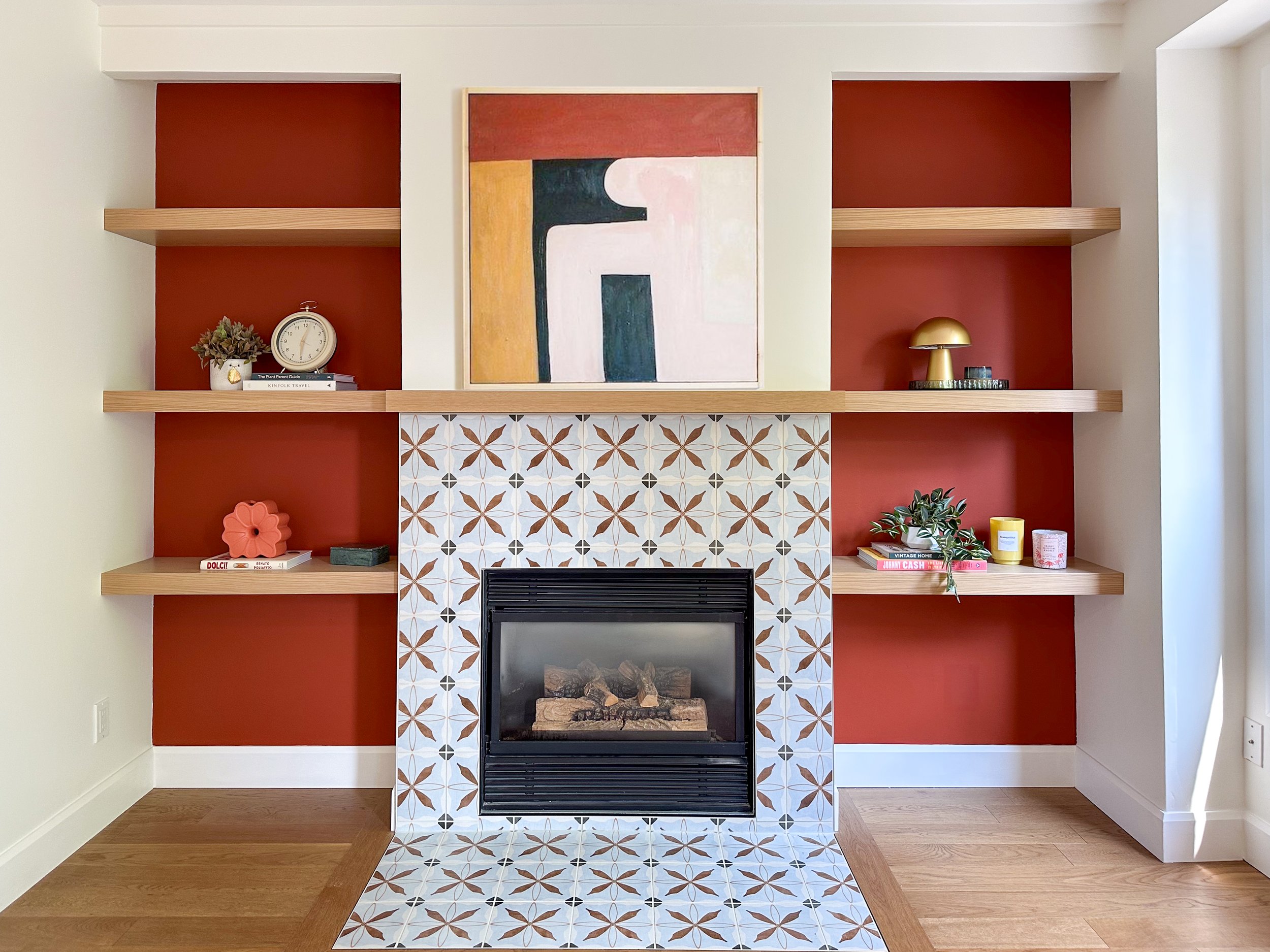 Custom Gas Fireplace with Encaustic Tile Surround, Custom Mantel and Floating Shelves.