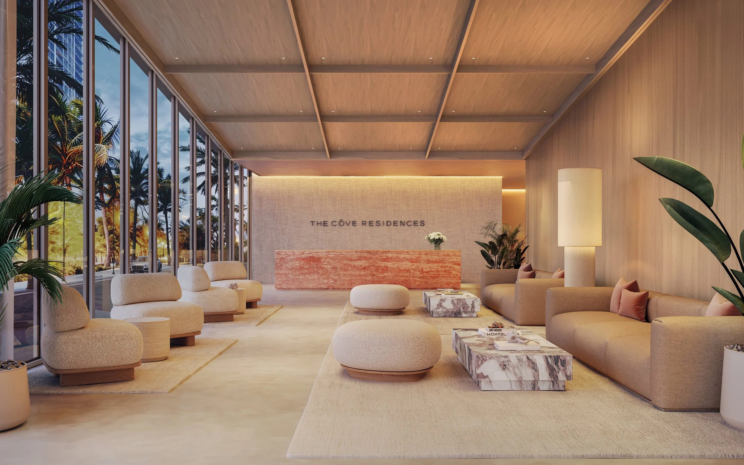 Modern hotel lobby with beige seating, marble coffee tables, plants, and large windows showcasing palm trees outside. Sign on a wall reads 'The Cove Residences'.