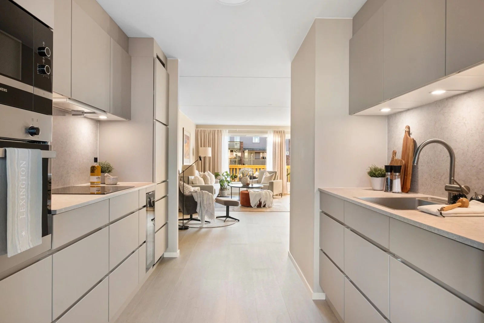 An image of a kitchen with insight to the livingroom