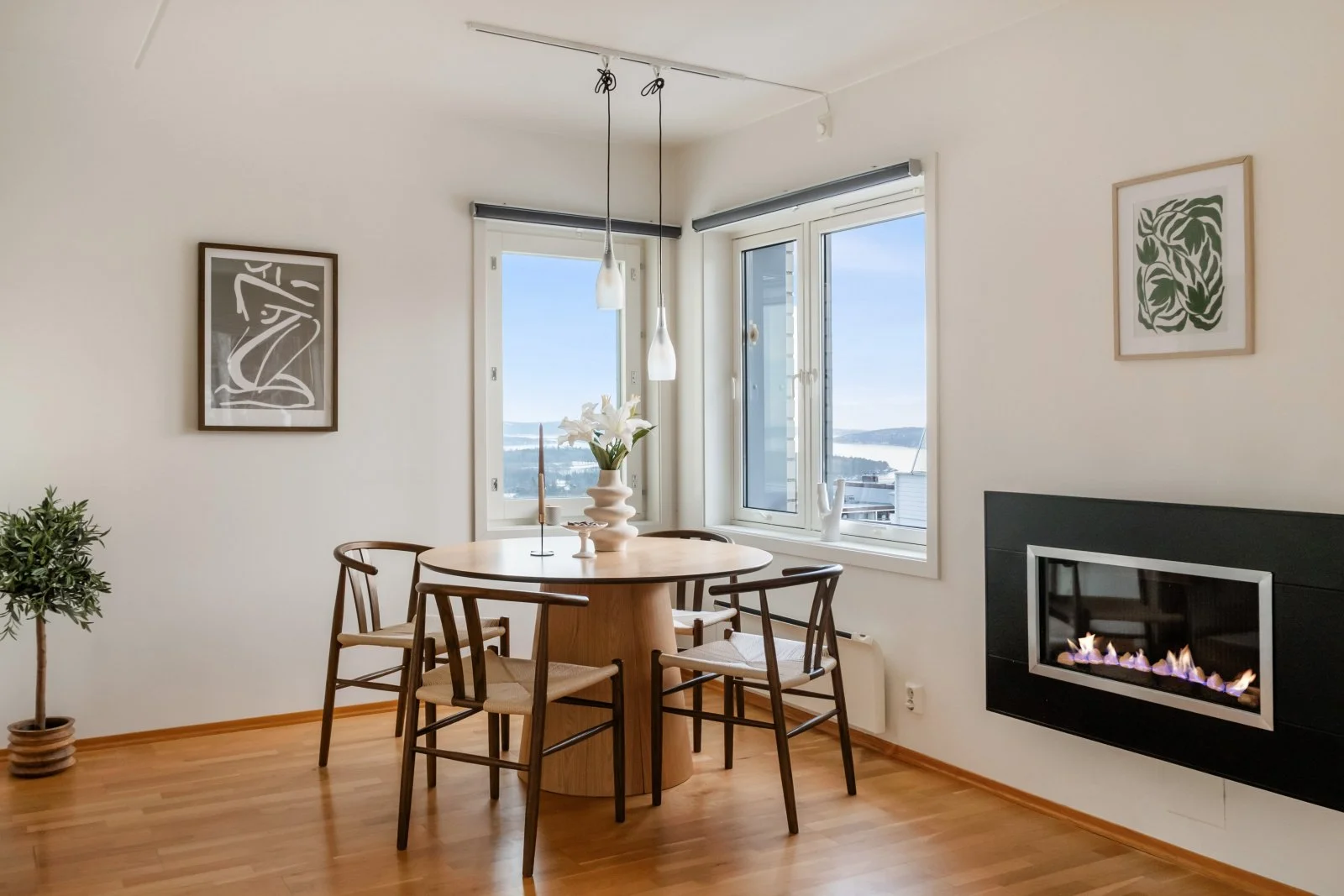 An image of a dining table witch chairs and decor