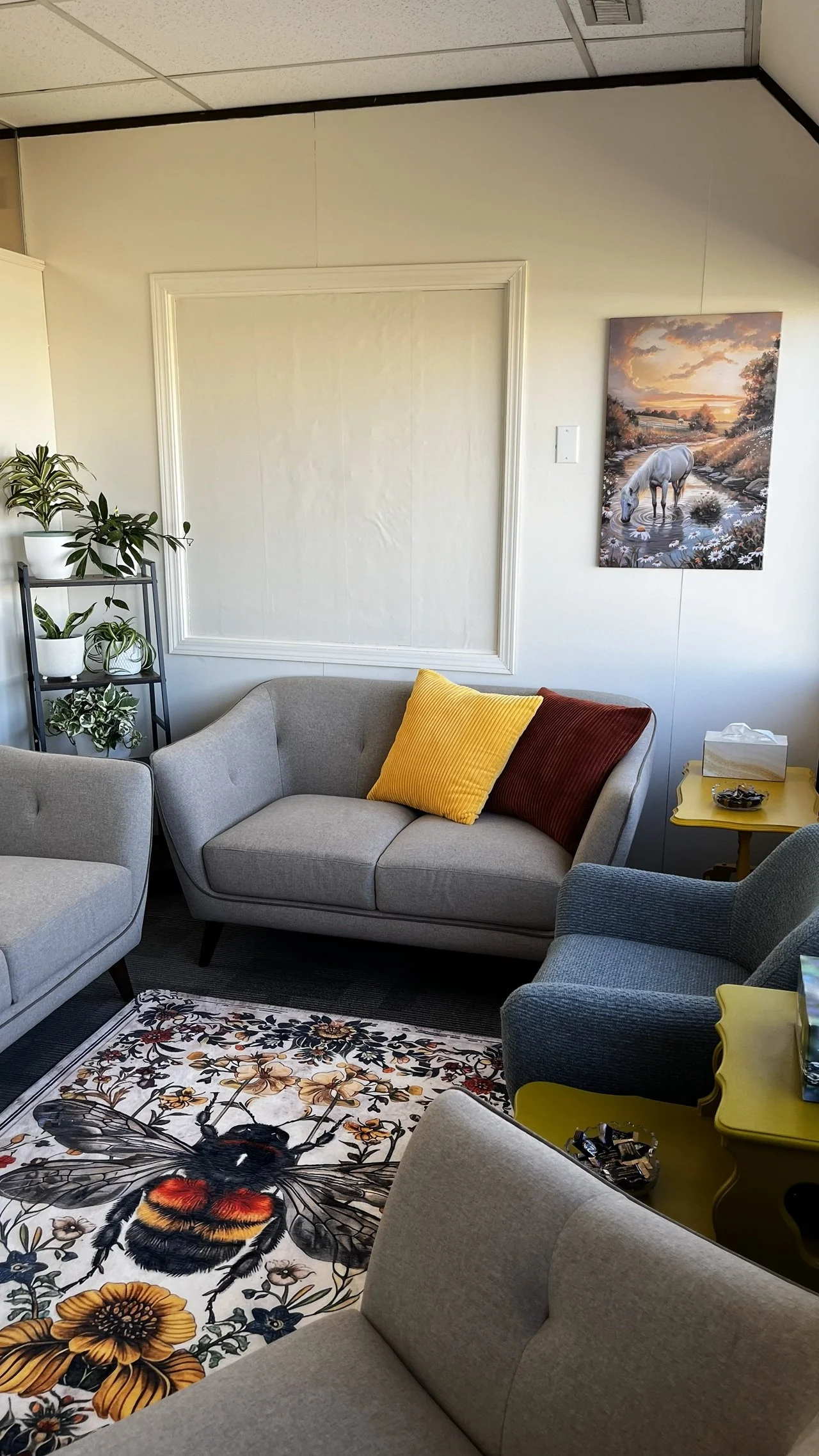 The loveseat, rug, blue chair and horse painting.