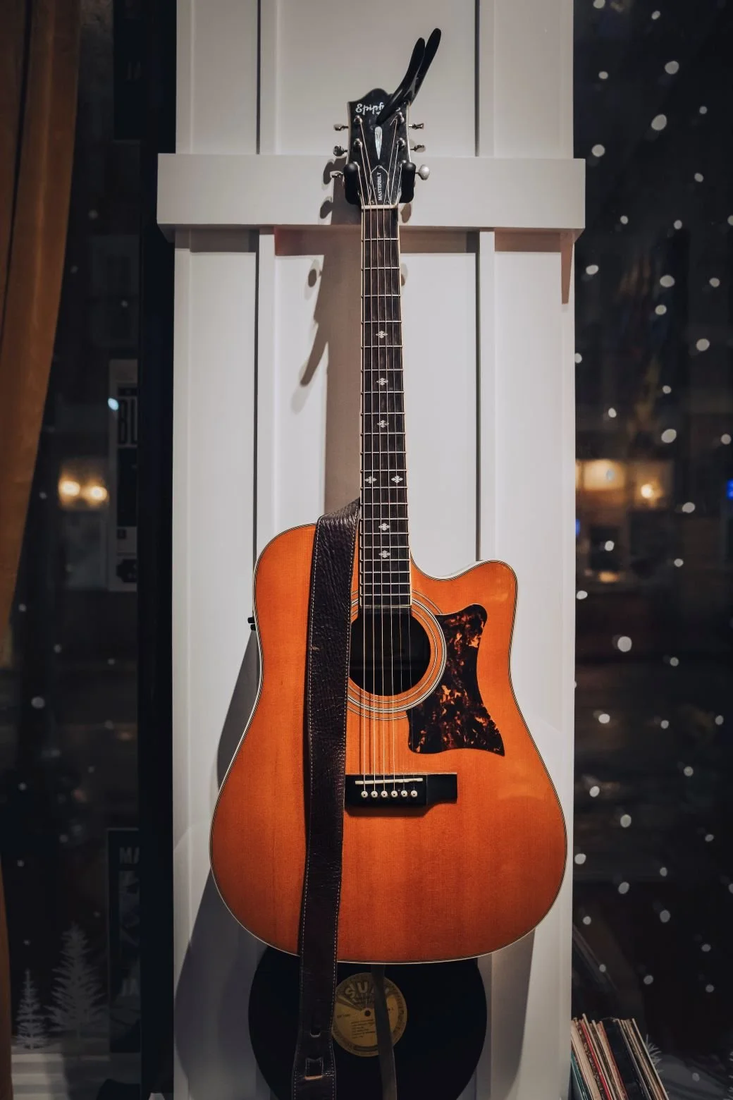 Photo of an epiphone guitar hanging in LoCali