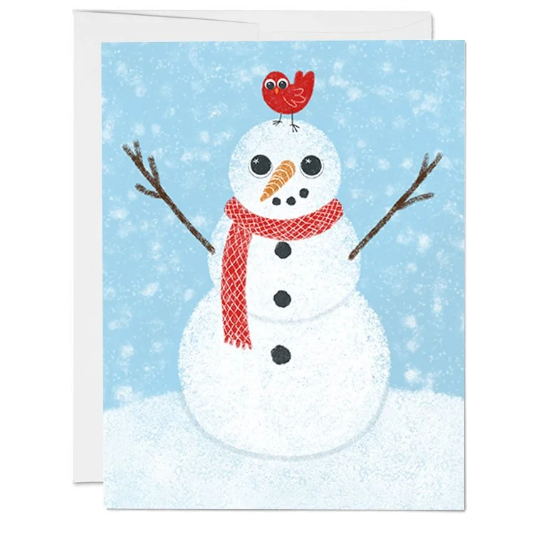 A greeting card with a snowman with a carrot nose, black button eyes, and a red scarf, built in a snowy scene with a blue background. A red bird is perched on top of its head.