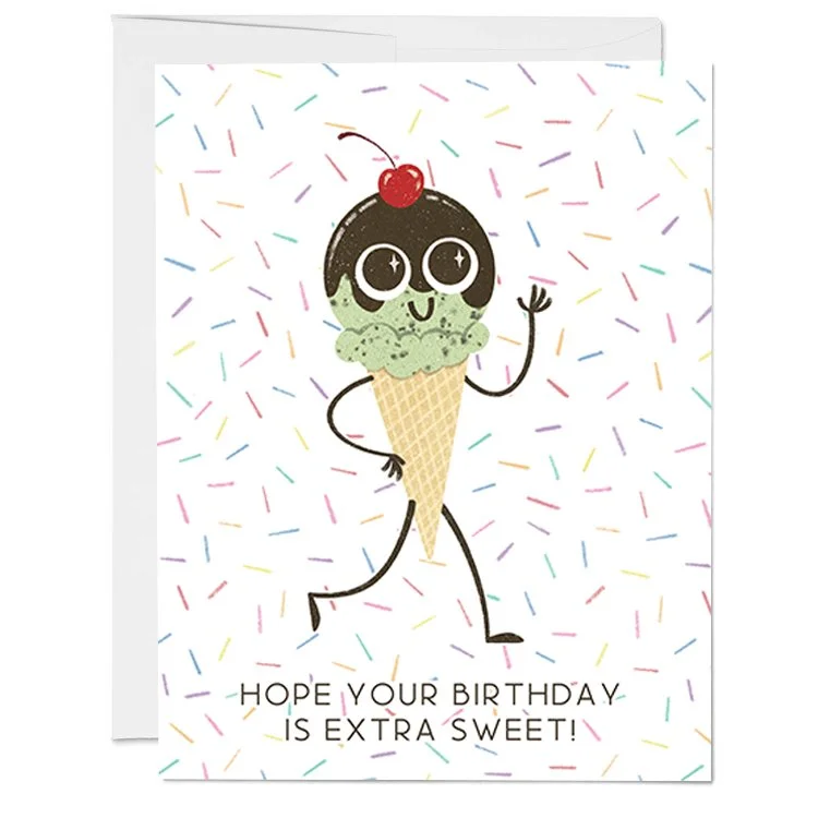 A colorful birthday card featuring a cartoon ice cream cone with a face, eyes, and a cherry on top, set against a background with rainbow-colored sprinkles. The card has the message 'Hope your birthday is extra sweet!' written at the bottom.