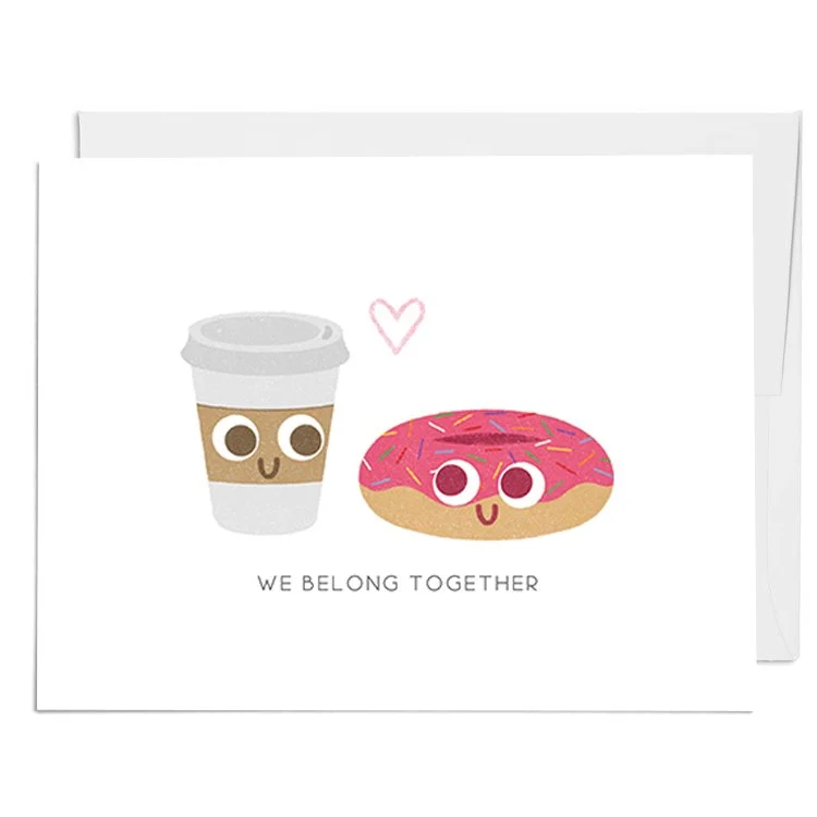 Illustration of a coffee cup and a donut with pink icing and sprinkles, smiling, with a pink heart above them and the words "We belong together."