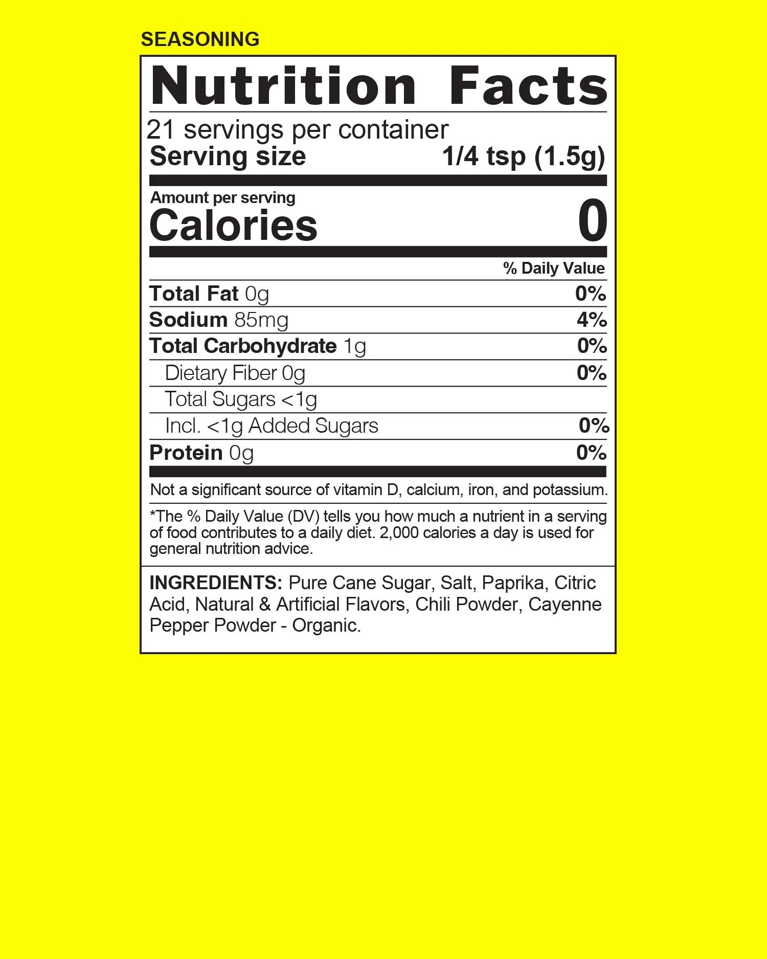 Close-up of a nutrition facts label for a seasoning product. The label states 21 servings per container, serving size of 1/4 teaspoon (1.5 grams), and shows zero calories, zero total fat, 85 milligrams of sodium (4% daily value), 1 gram of total carbohydrate, and zero protein per serving. The ingredients listed include pure cane sugar, salt, paprika, citric acid, natural and artificial flavors, chili powder, cayenne pepper powder, and organic seasoning.