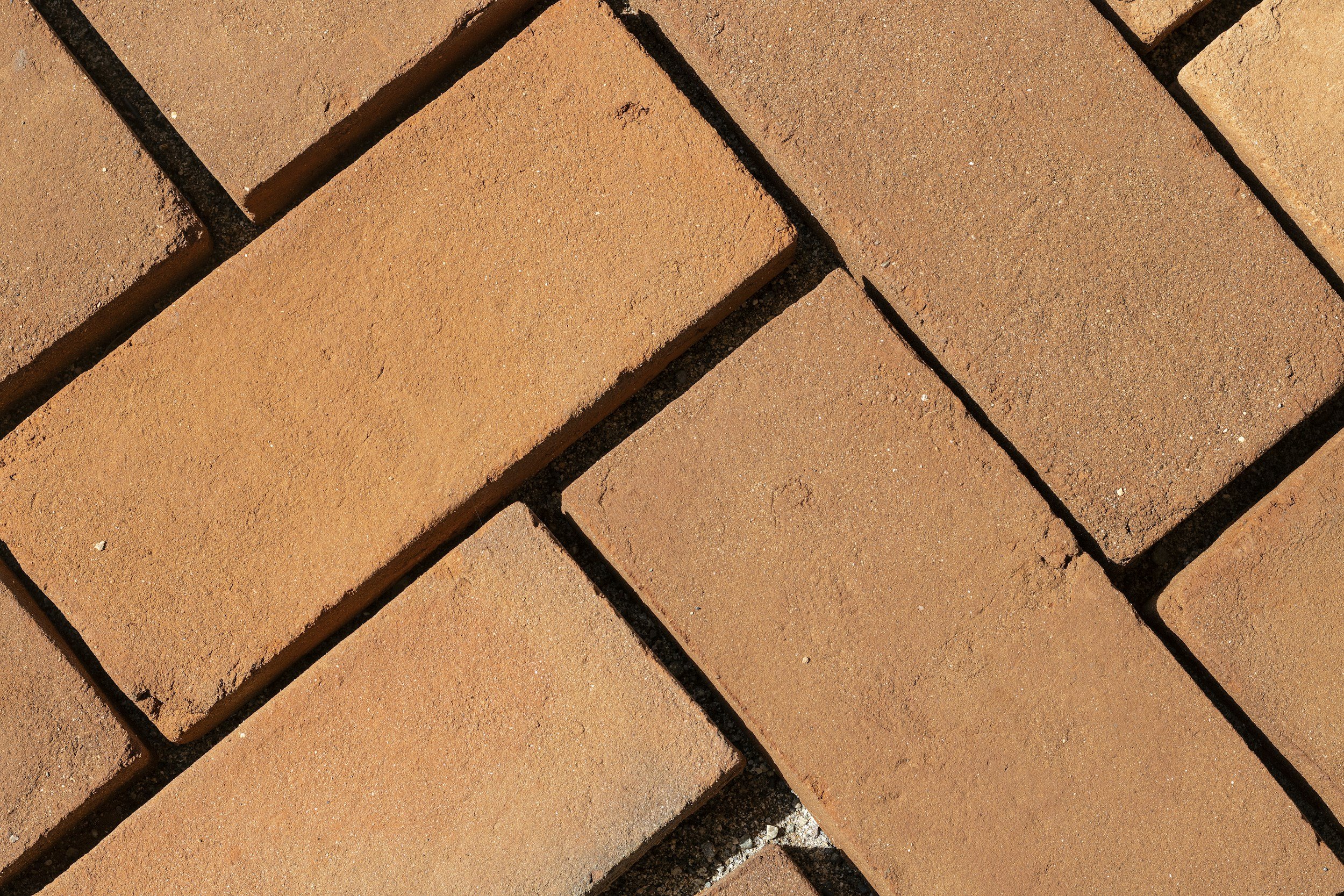 Close-up of red clay bricks arranged in a pattern with visible mortar lines.