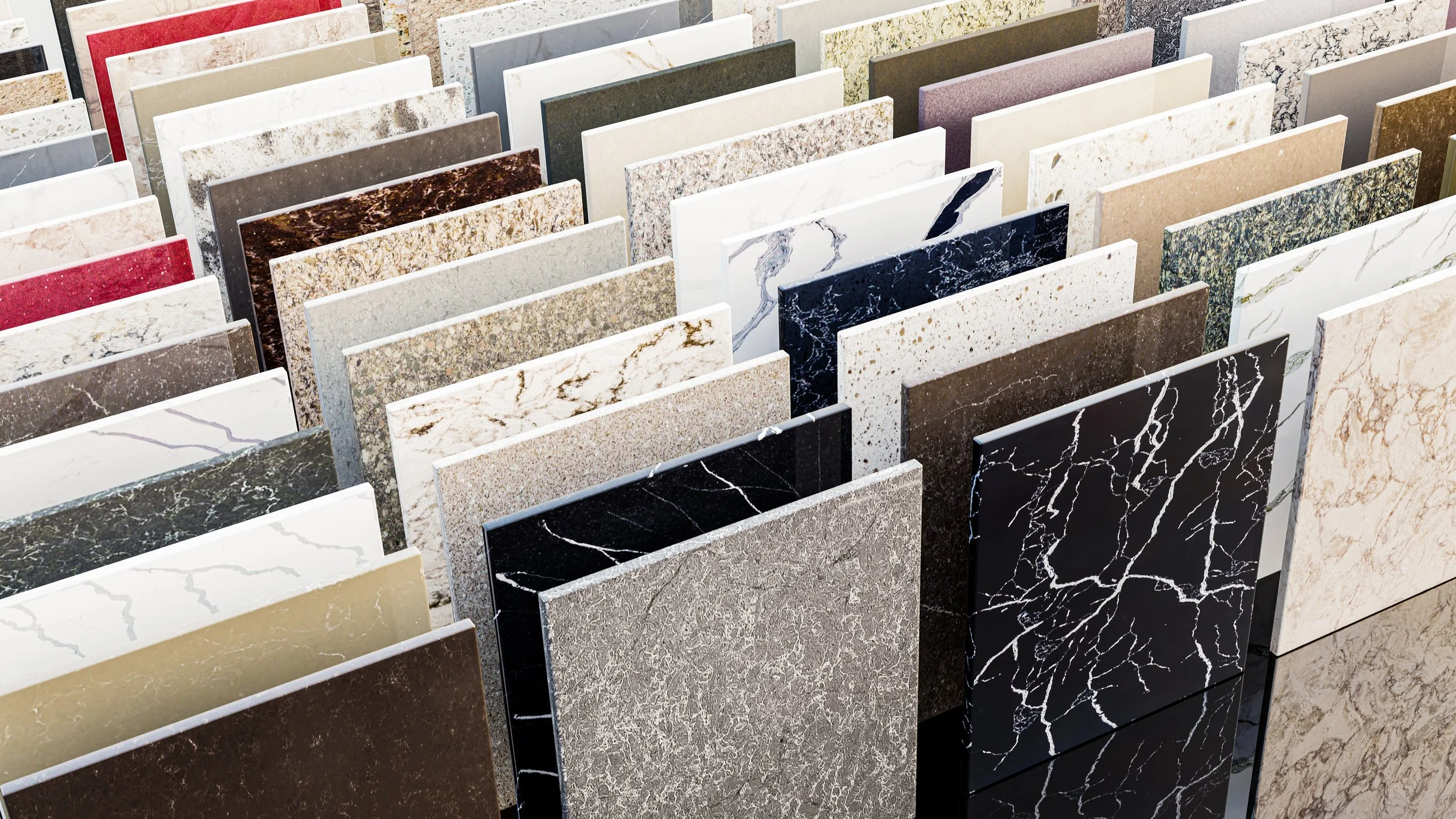 Various slabs of marble and granite in different colors and patterns displayed in a showroom.