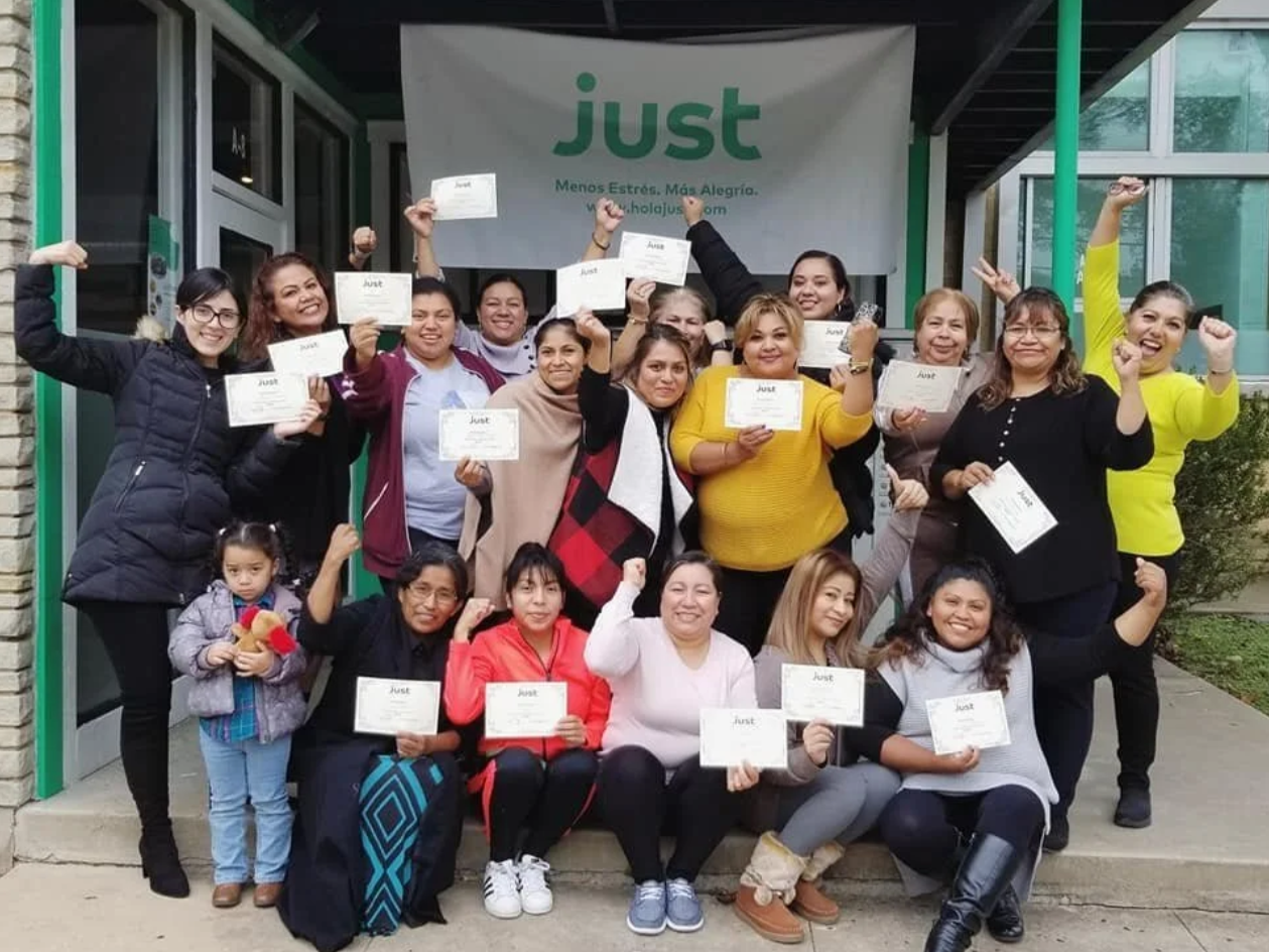 A group of women in the JUST program holding up certificates