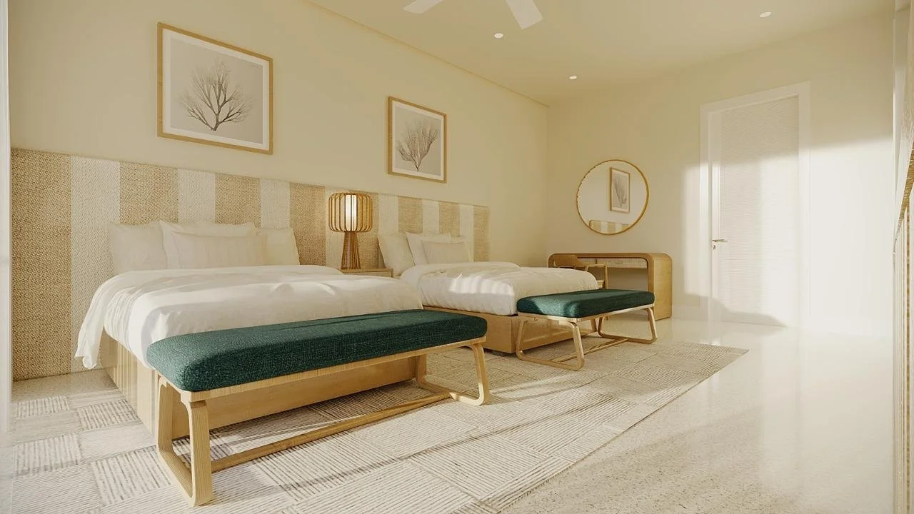 Habitación con dos camas grandes, un espejo redondo en la pared y ventanas que dejan entrar luz natural.