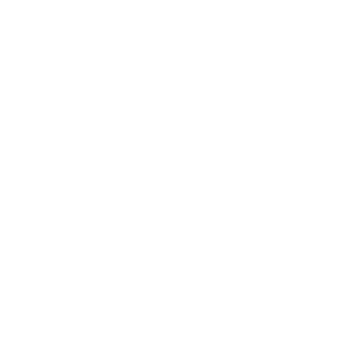 Two people sitting at a table, exchanging conversation in a discussion or interview setting.
