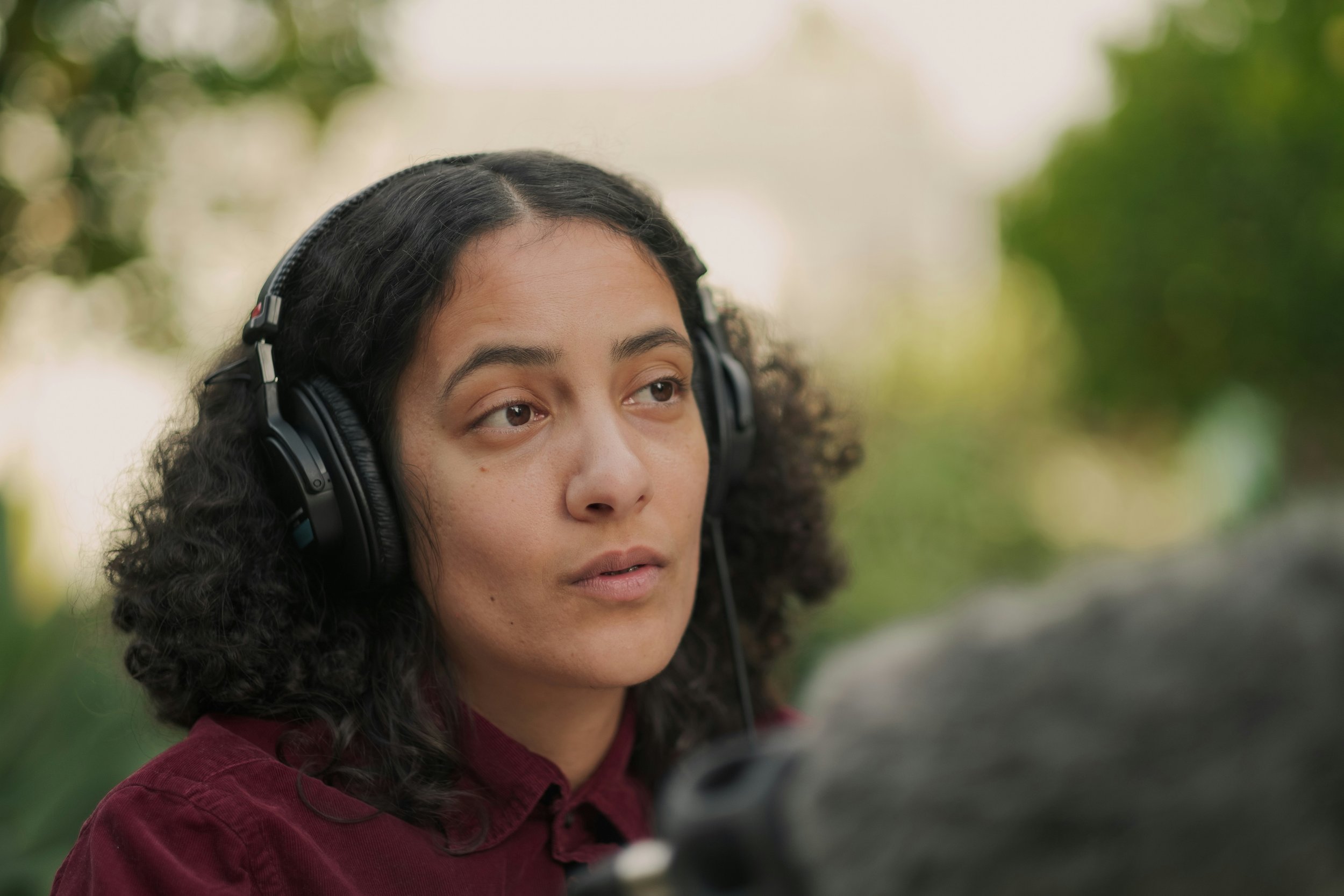 a-reporter-wearing-headphones conducting an interview