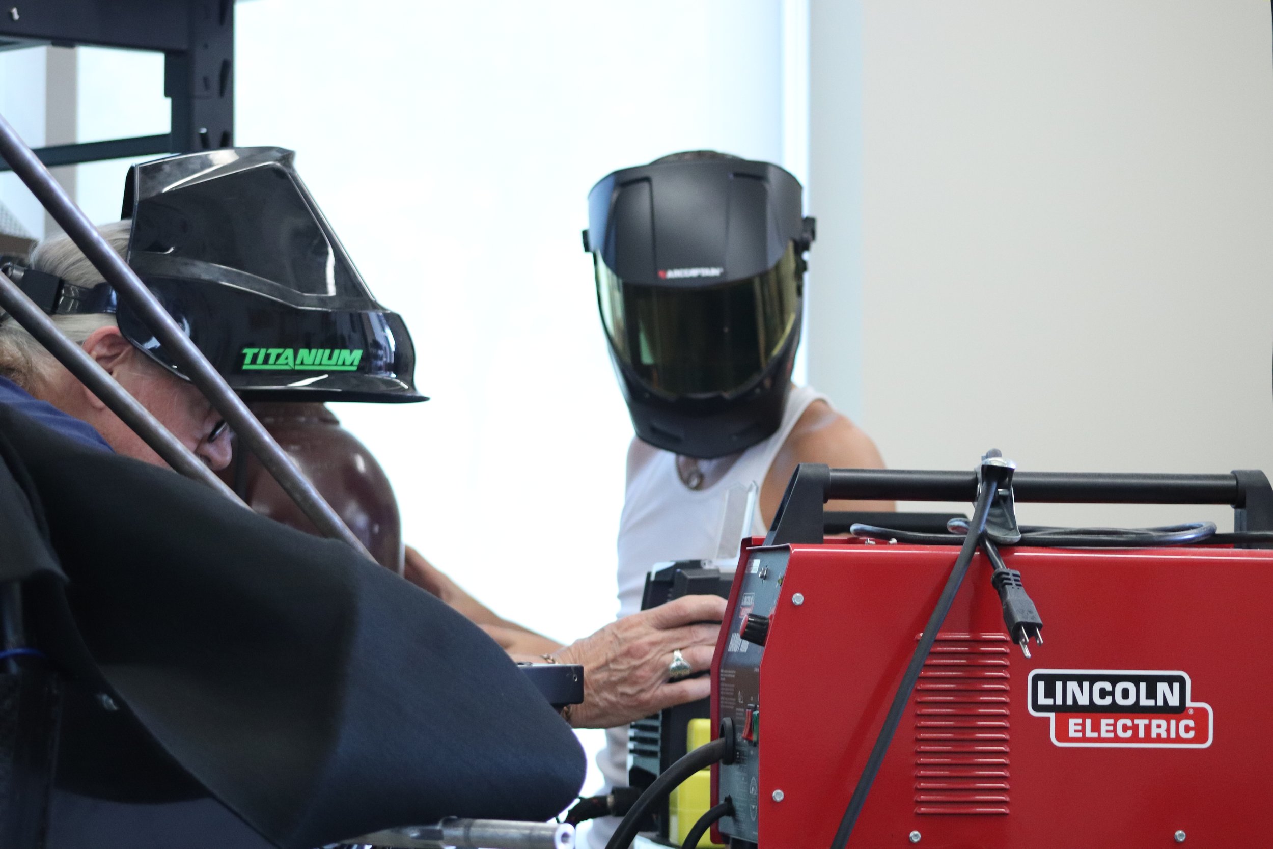 Hunter and his grandfather welding together the new roll bar and installing it