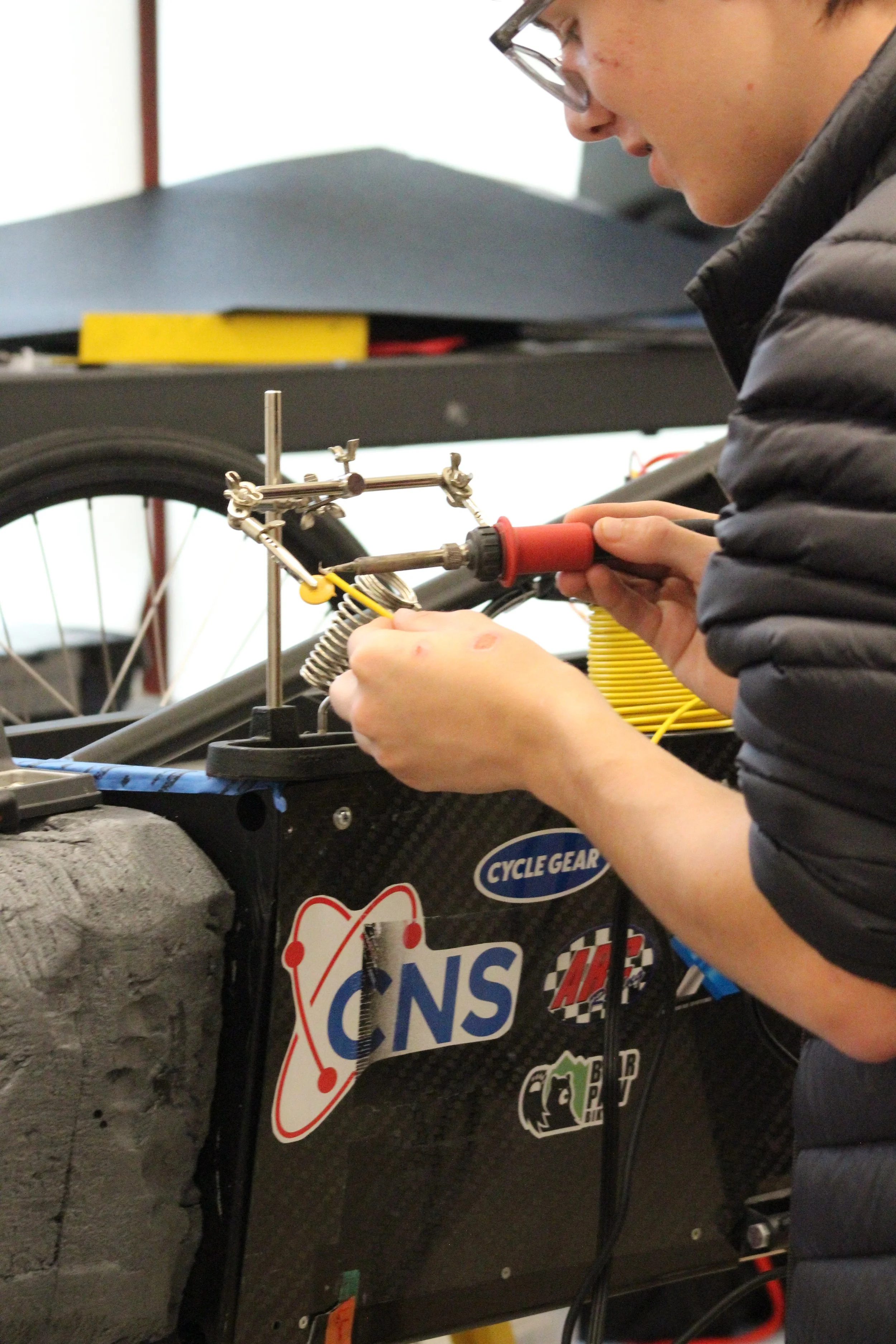 Bryan is working on soldering filtering capacitors for the electronic speed controller (ESC)