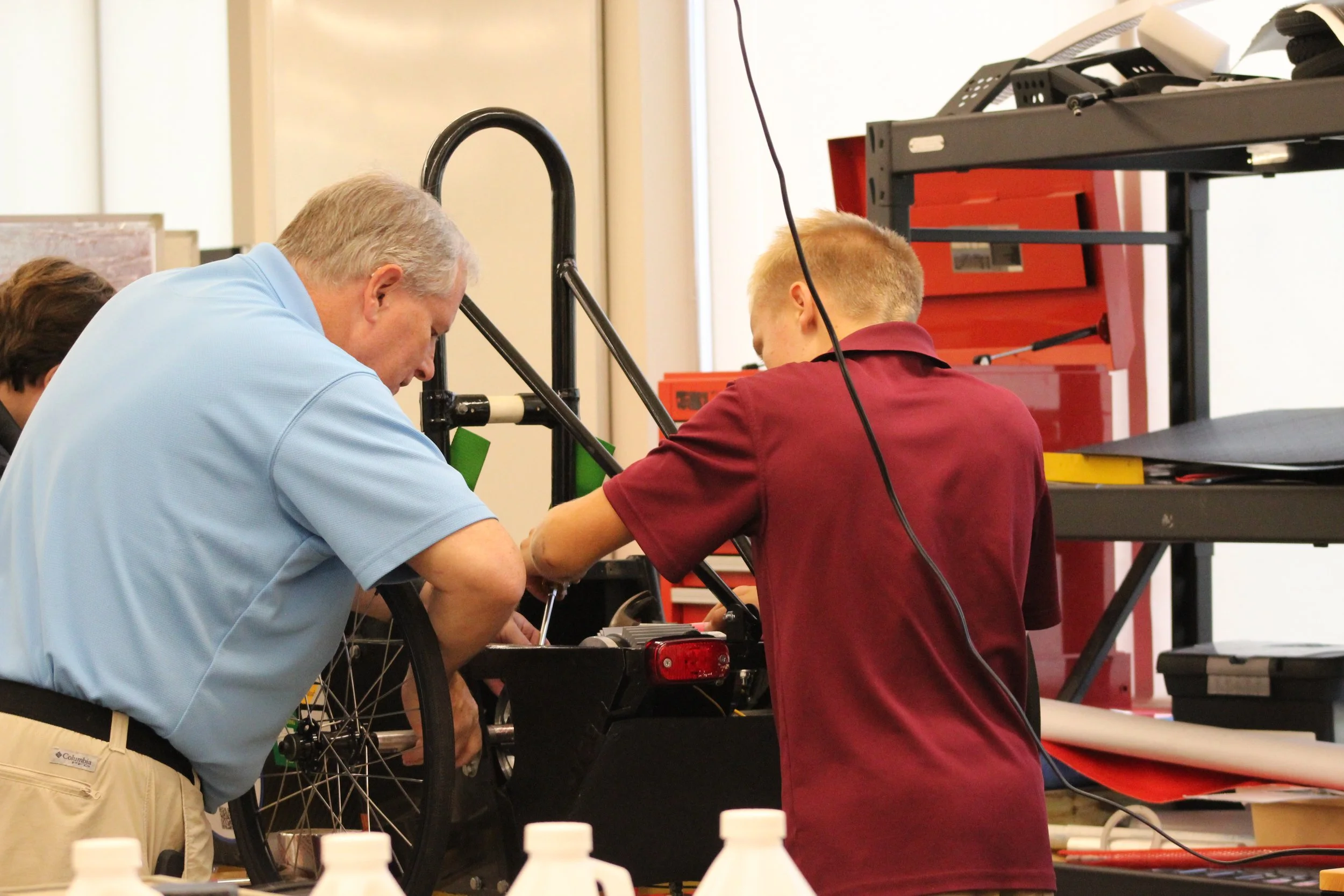 Mr. Sluder and Hunter working on the back end of the car