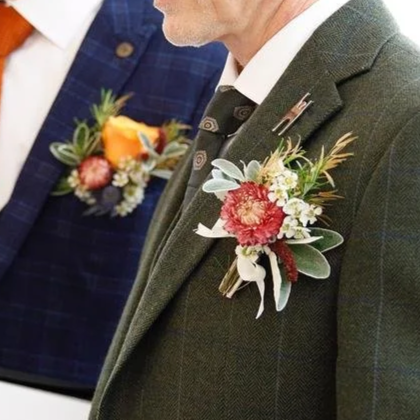 Men wearing suits with boutonniere floral arrangements on lapels