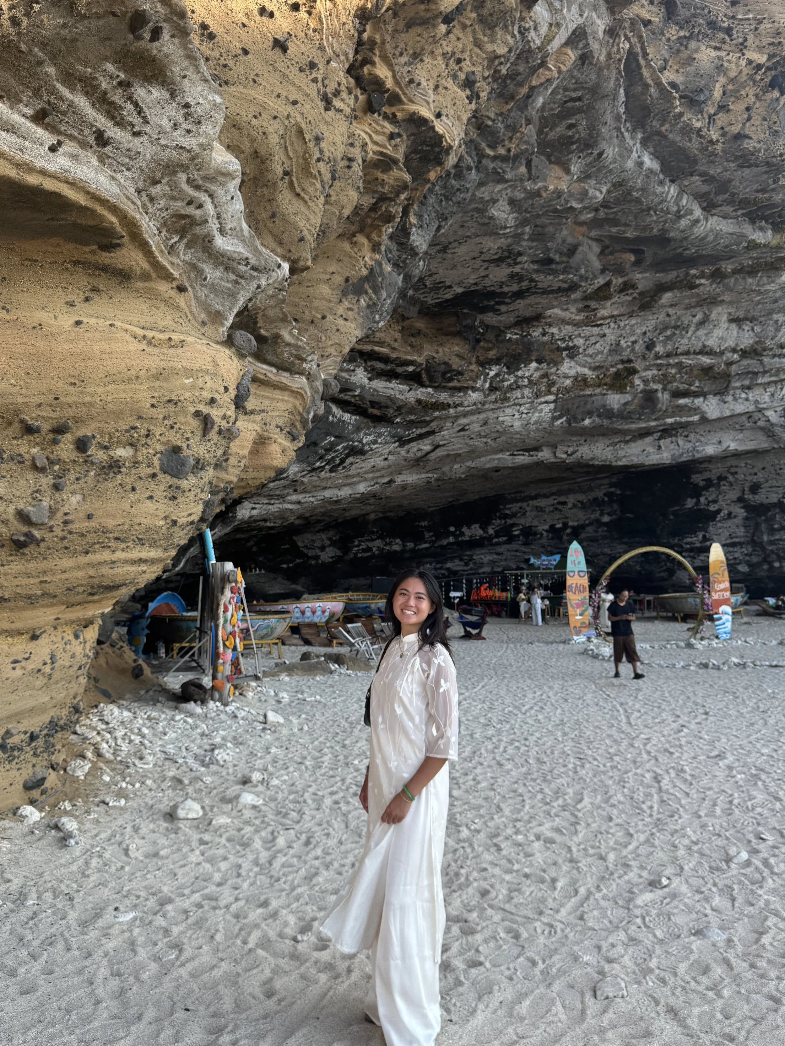 Val dressed in a white Áo dài.