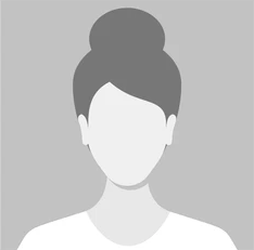 Silhouette of a woman with a bun hairstyle against a gray background.