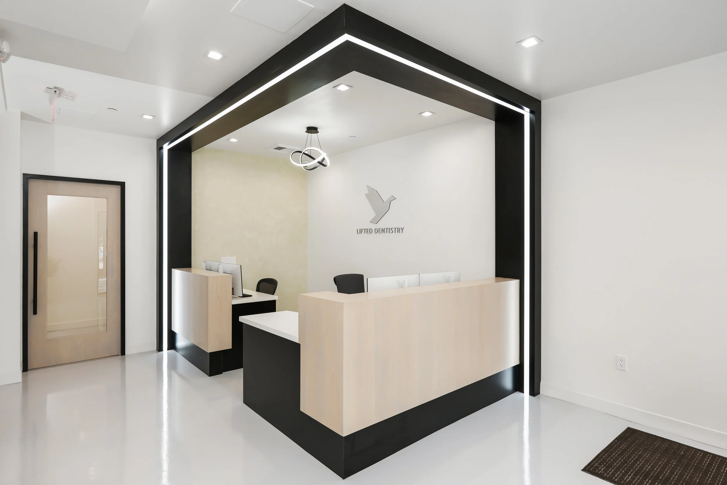 Irvine CA.  This shows a dental office reception with custom lighting and a clean contemporary aesthetic.