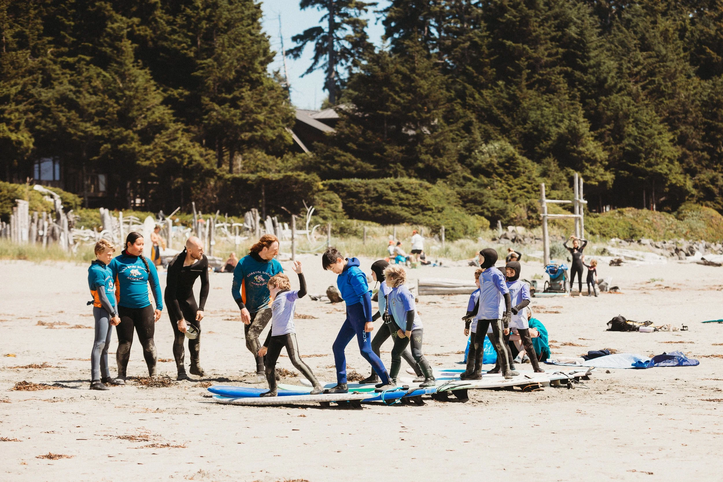 kids summer beginner surf camp in tofino with coastal shred academy at north chesterman beach in a surf lesson