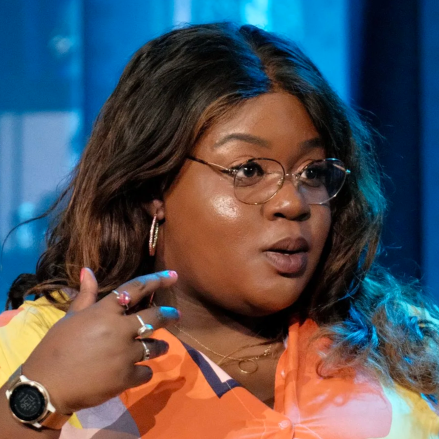 Headshot of Candi Williams, a Black woman with glasses and long dark hair wearing a colorful patterned top.